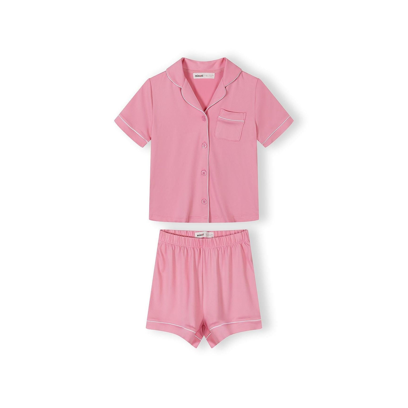 Pink pyjama set laid flat showing short sleeve button-up top with collar and pocket, matching elasticated shorts with white piping trim