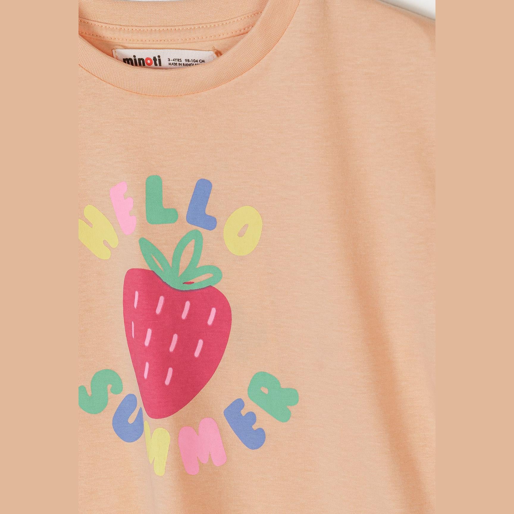 Close-up detail of apricot t-shirt showing Minoti label and Hello Sweet text with strawberry graphic design featuring colourful letters