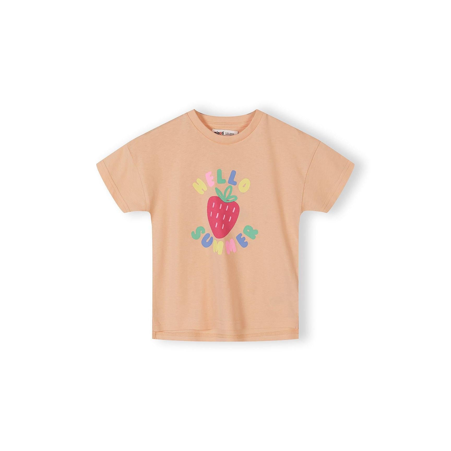 Single apricot-coloured t-shirt with all-over fruit print pattern showing pineapples, watermelons, strawberries and other fruits in bright colours on white background