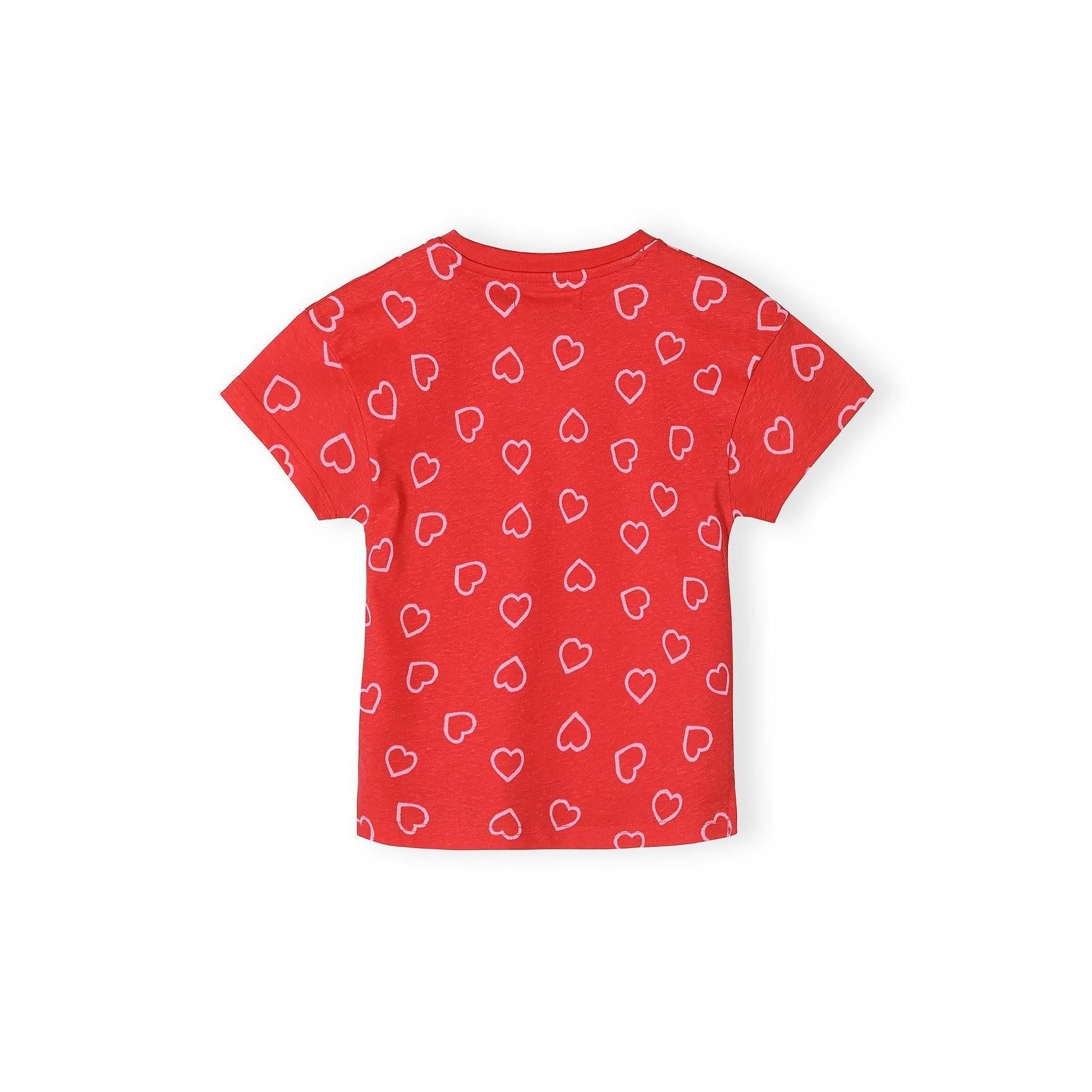 Detail shot of coral red t-shirt featuring white heart outline pattern scattered across the fabric with Minoti label at neckline