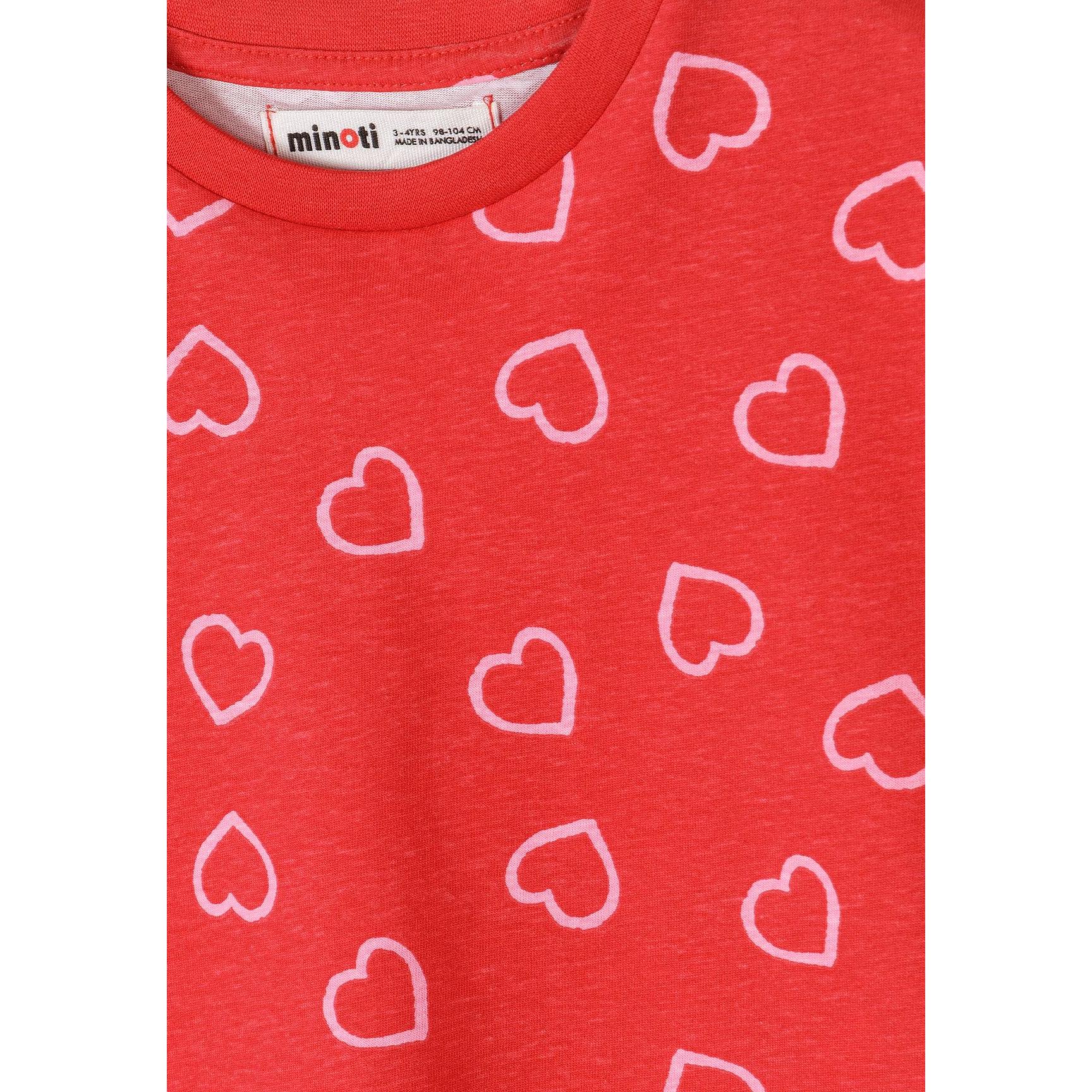 Detail shot of coral red t-shirt featuring white heart outline pattern scattered across the fabric with Minoti label at neckline