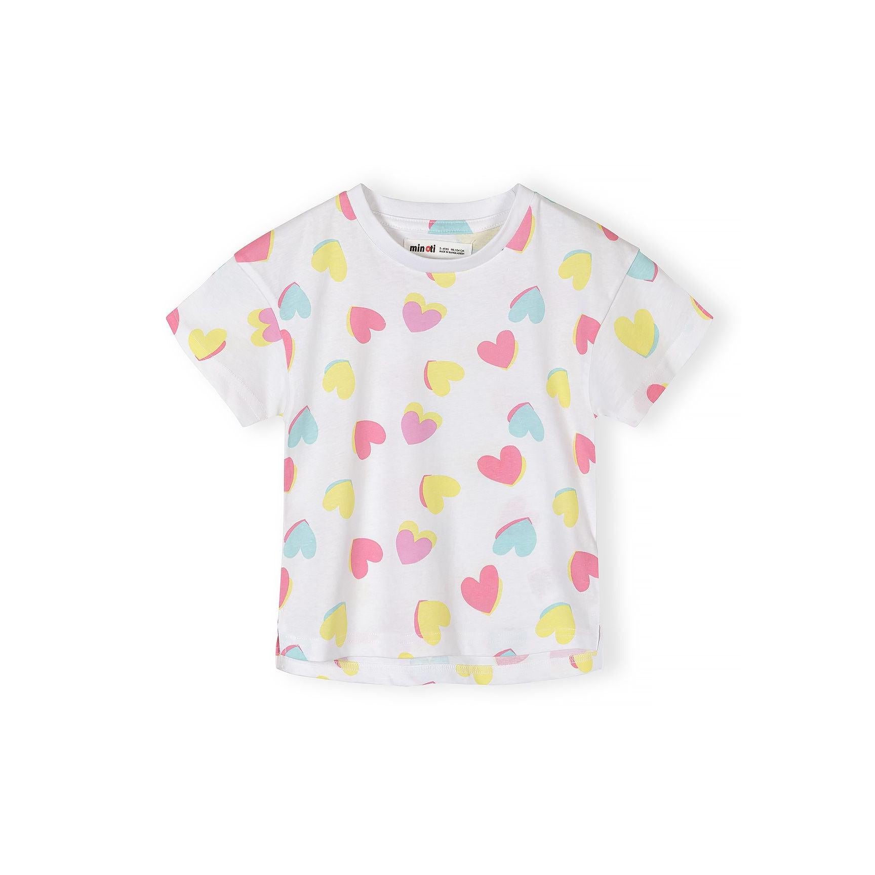 Flat lay of white cotton t-shirt with colourful heart print pattern in pink, yellow and blue hearts scattered across the fabric