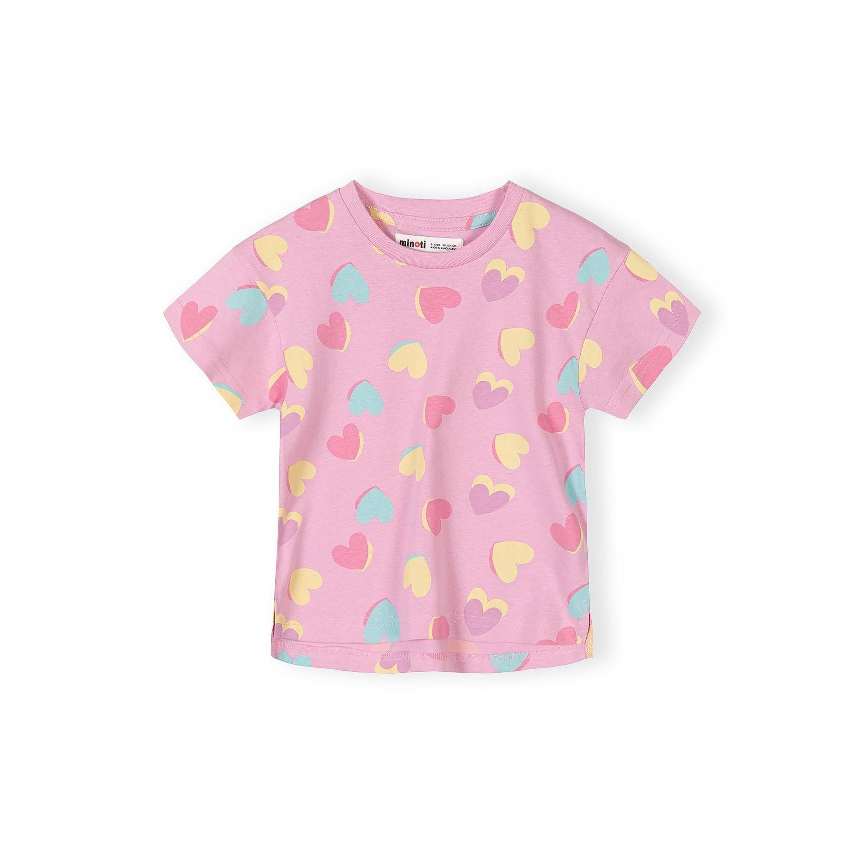 Close-up detail of white t-shirt showing Summer in Bloom print with smiling daisy flowers in pink and blue with yellow centers and green leaves