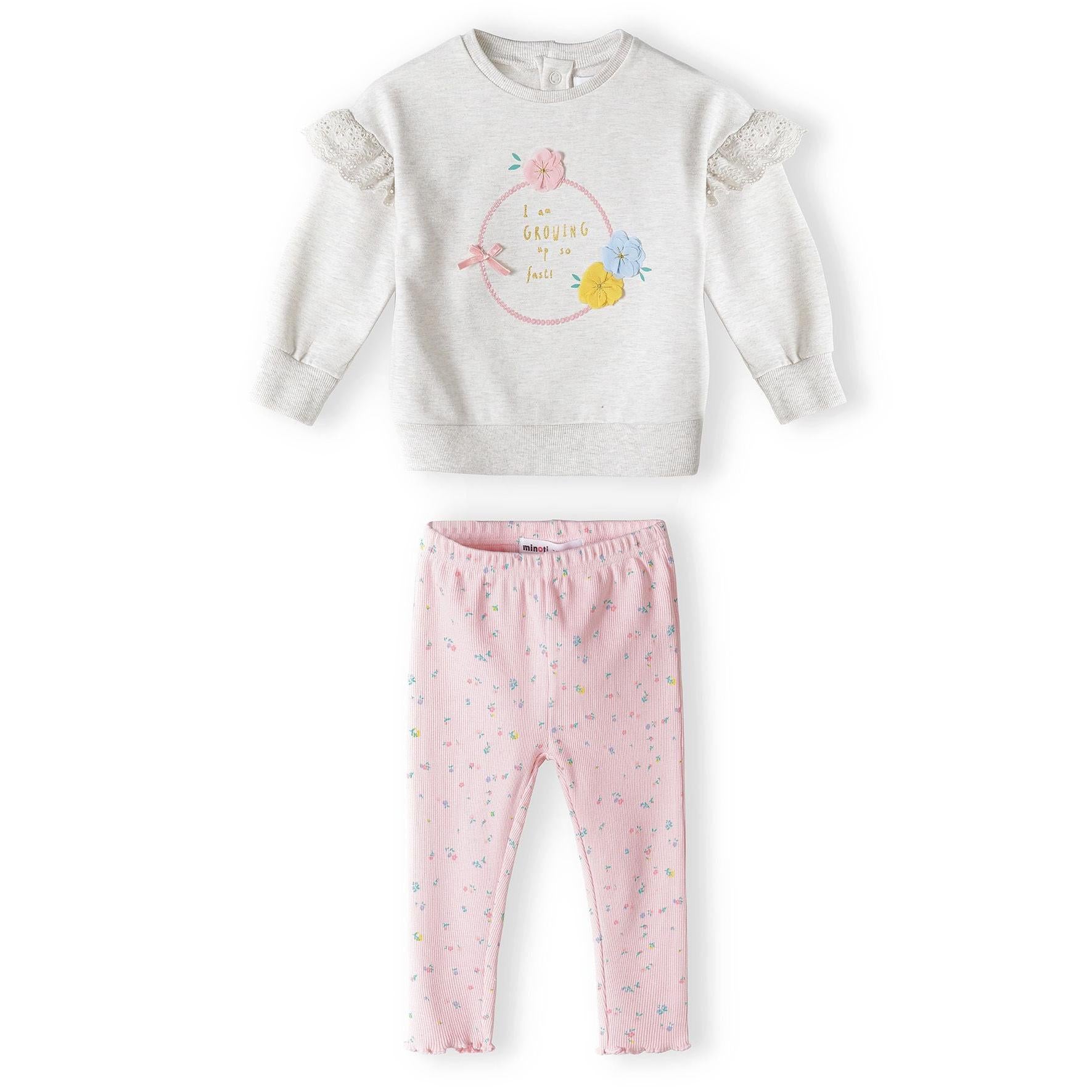 Back view of beige fleece sweatshirt showing button closure at neck and delicate lace frill details on sleeves against white background