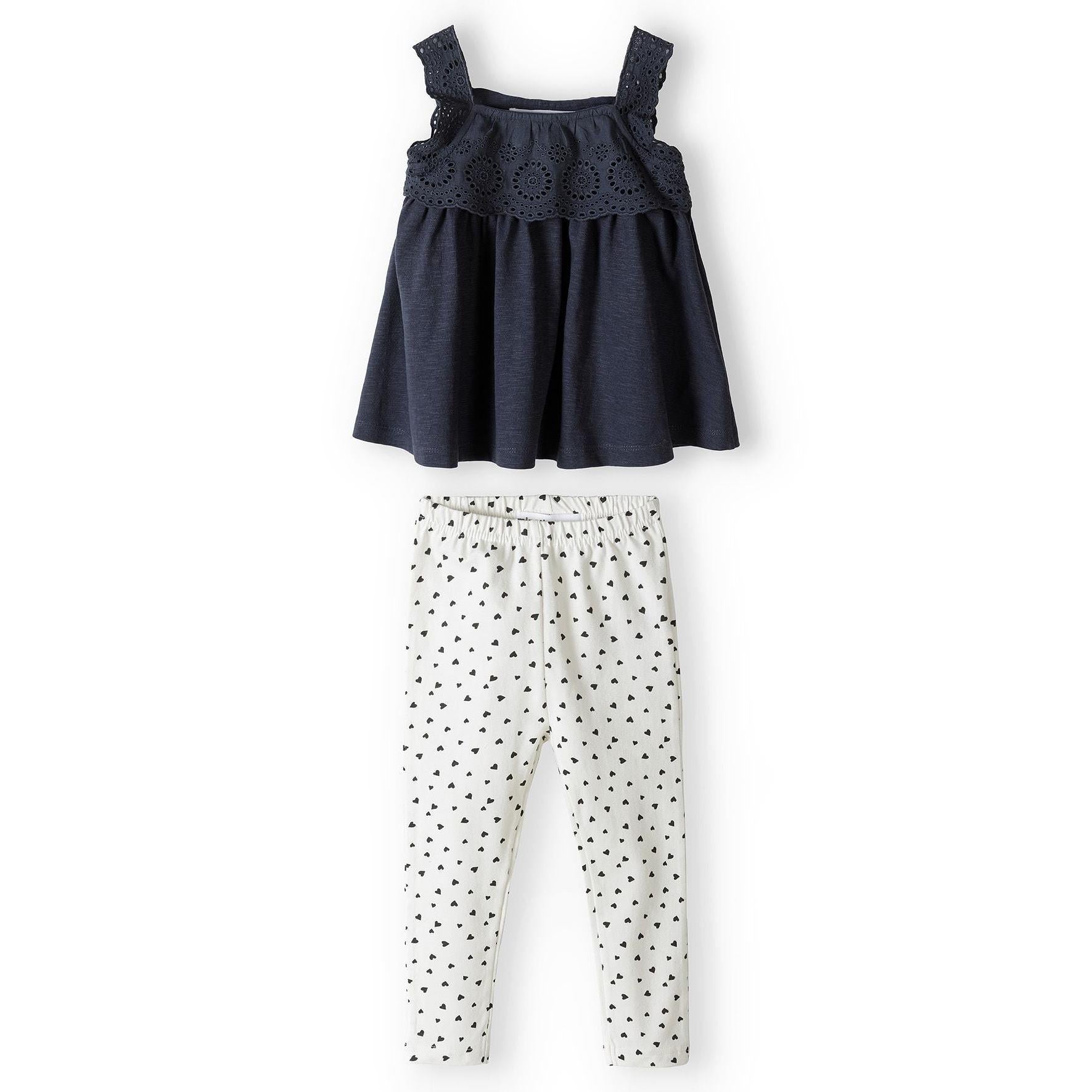 Grey broderie anglaise sleeveless top with ruffle neckline detail and shoulder straps, laid flat on white background