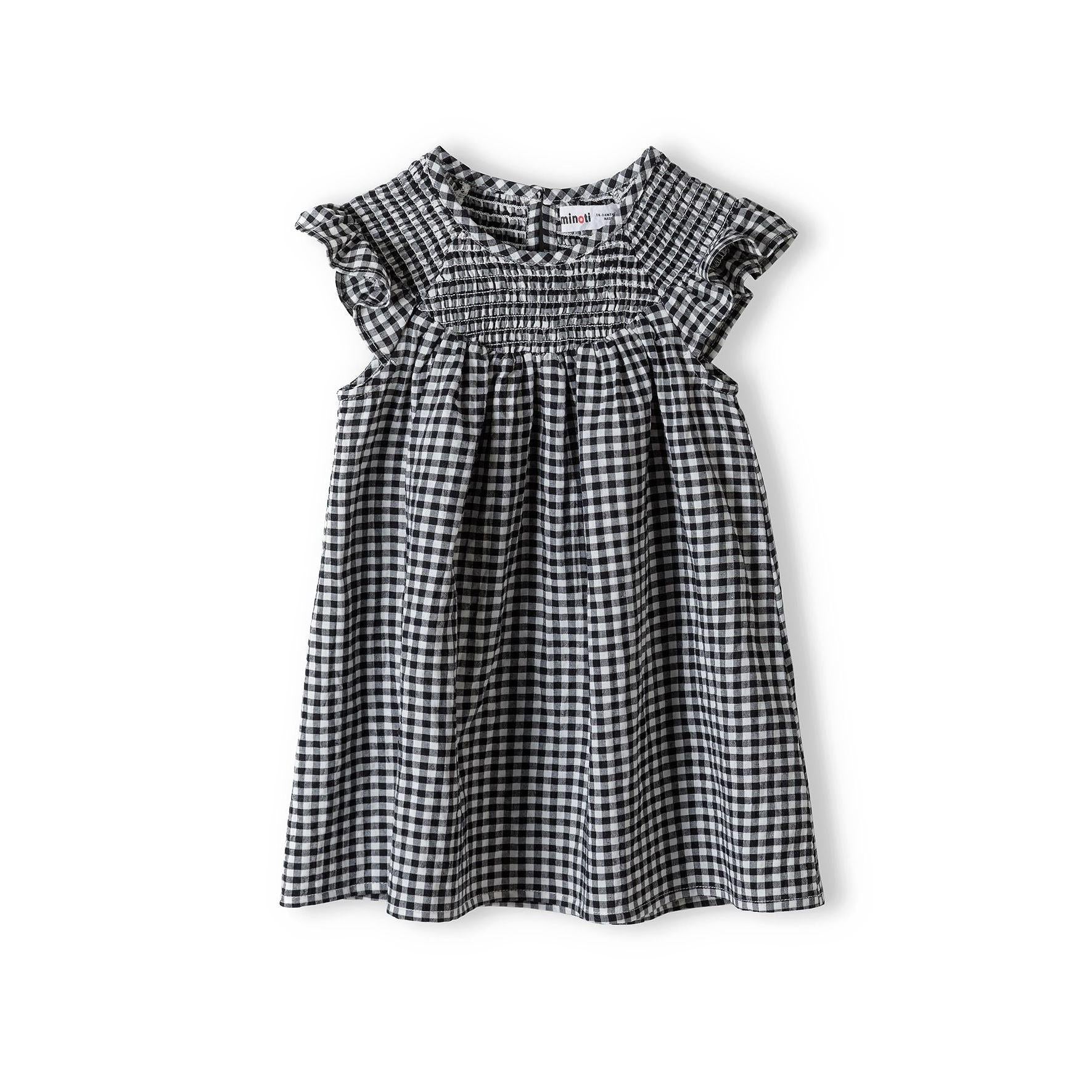 Grey gingham smock dress laid flat on white background showing frill sleeve details, shirred neckline and overall construction