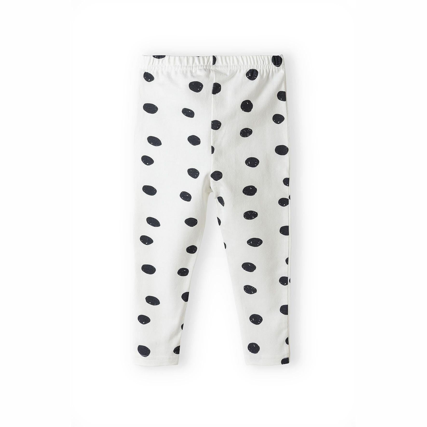 White leggings with black polka dot pattern laid flat showing elasticated waistband, on white background