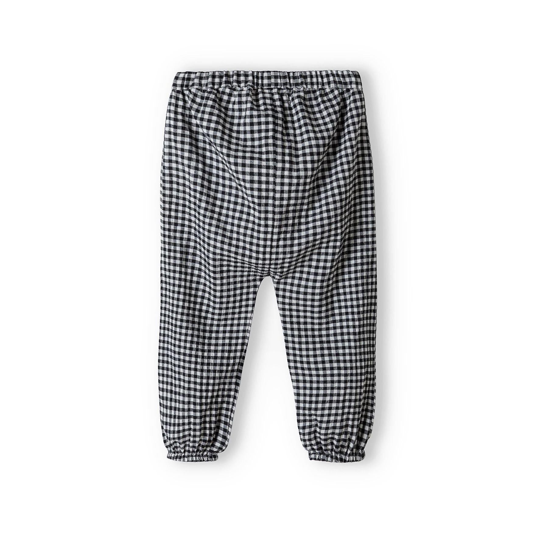 Black and white gingham check harem trousers with elasticated waistband and cuffs photographed flat on white background