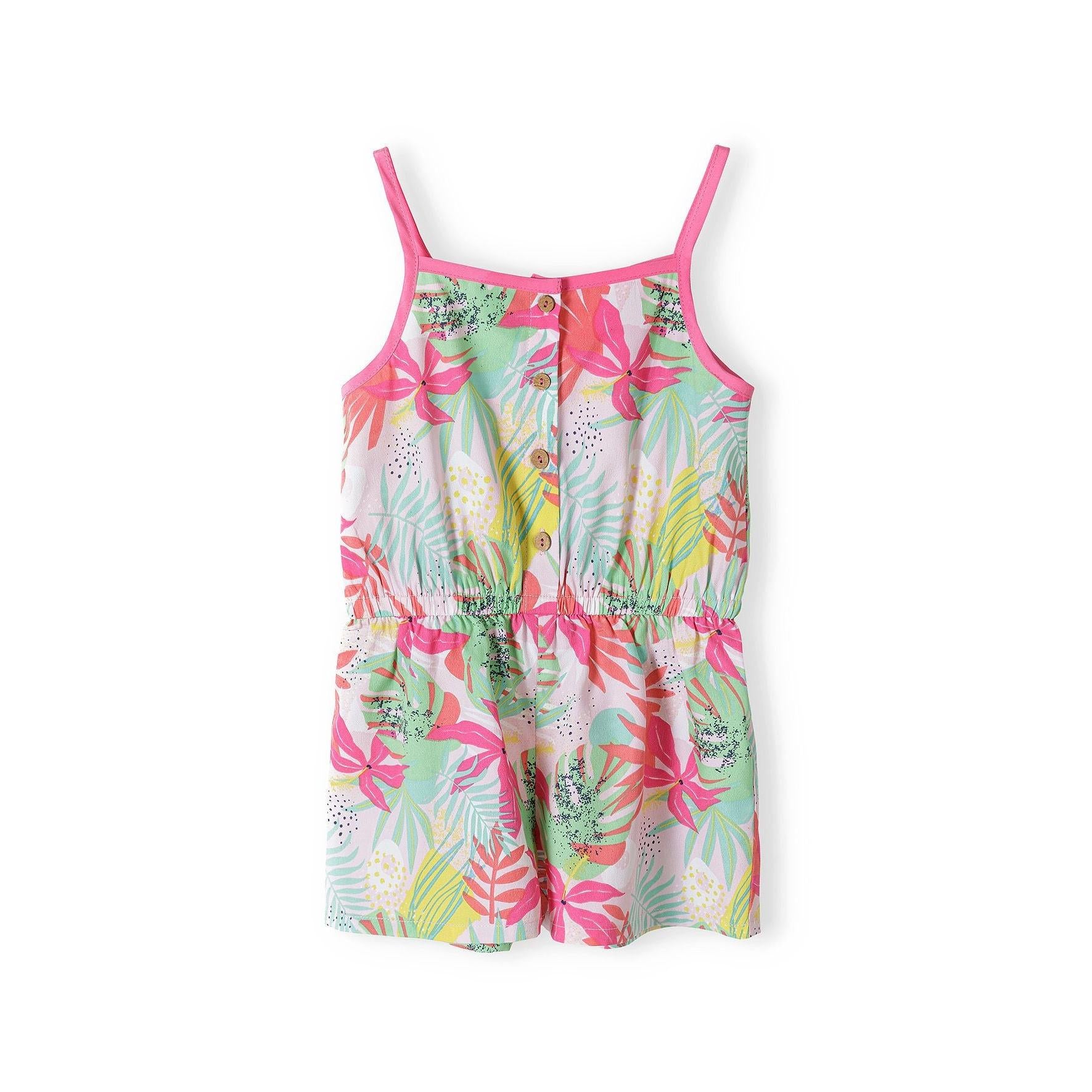 Flat lay of tropical print playsuit showing button-front closure, adjustable straps and vibrant botanical pattern in pink, green and coral tones