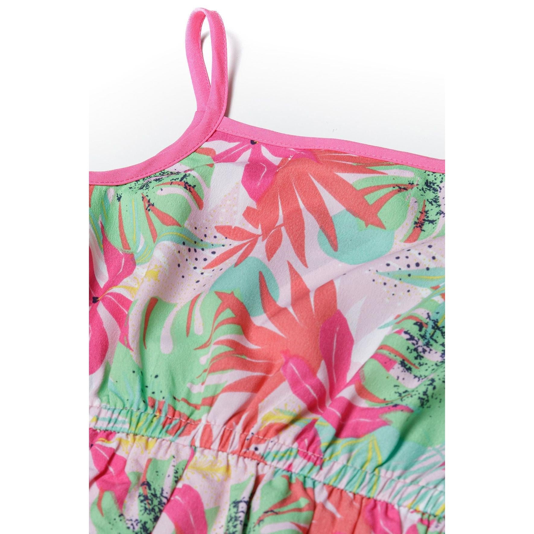 Close-up detail of tropical playsuit showing elasticated waistband, vibrant palm leaf print and pink binding trim on shoulder strap