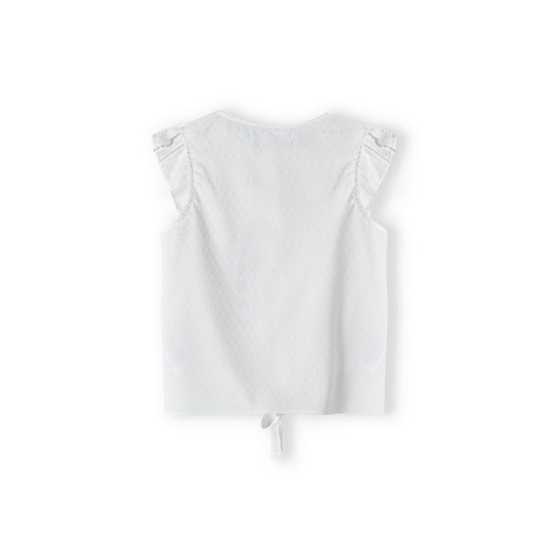 White broderie anglaise sleeveless top laid flat showing back view with ruffle cap sleeves and tie detail at bottom hem