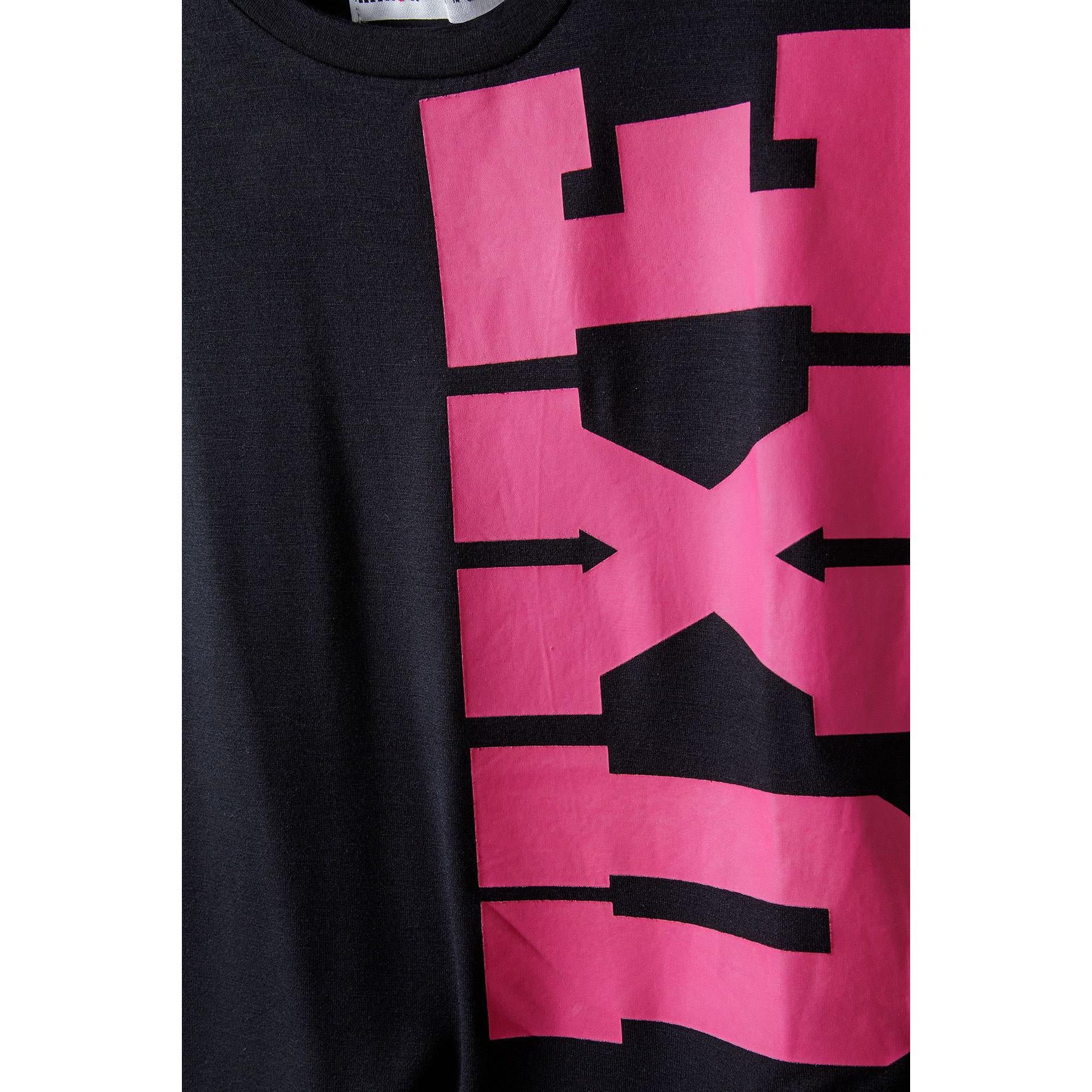 Close-up detail of bright pink graphic print on black fabric showing texture and design