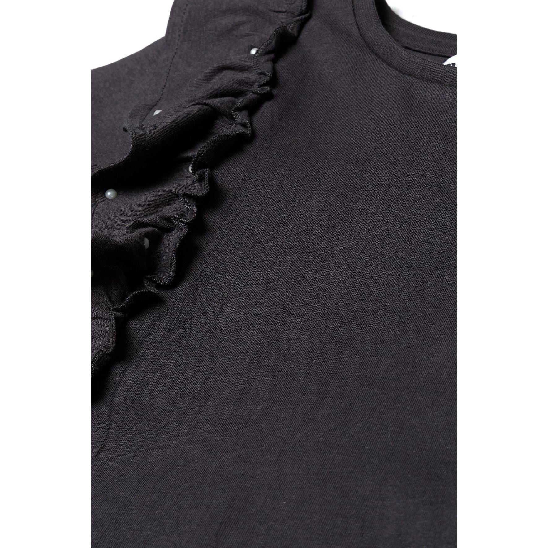 Close-up detail of black ruffle trim with pearl embellishments on jersey fabric showing texture