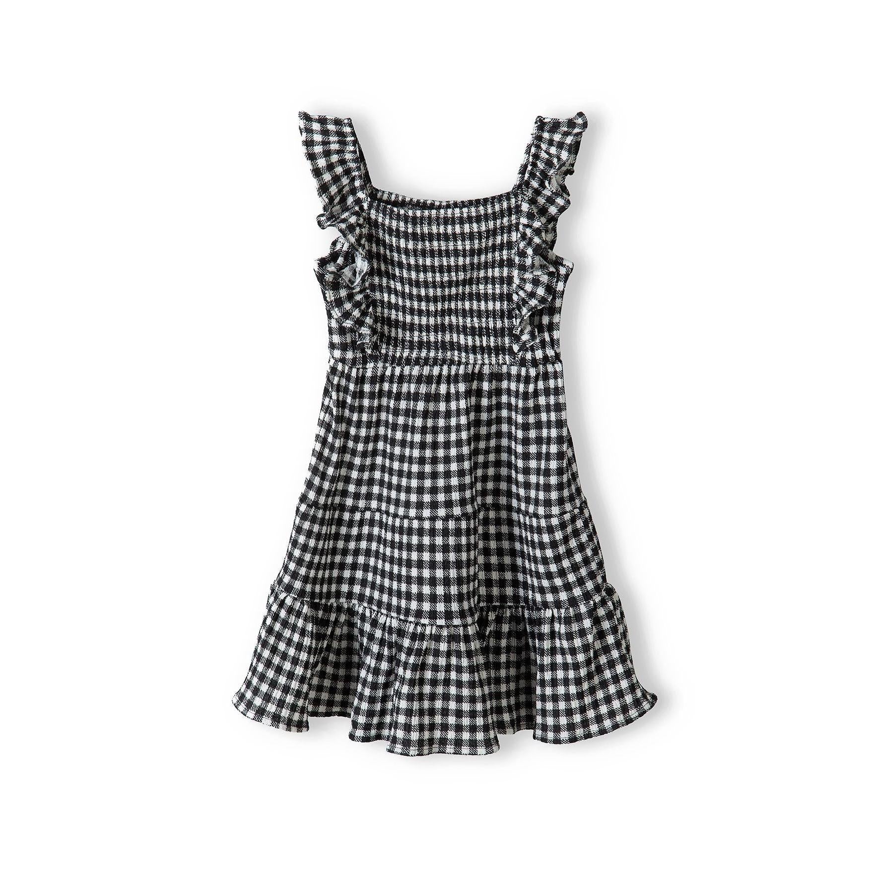 Black and white gingham tiered dress laid flat showing shirred bodice, flutter sleeves and three-tier skirt construction