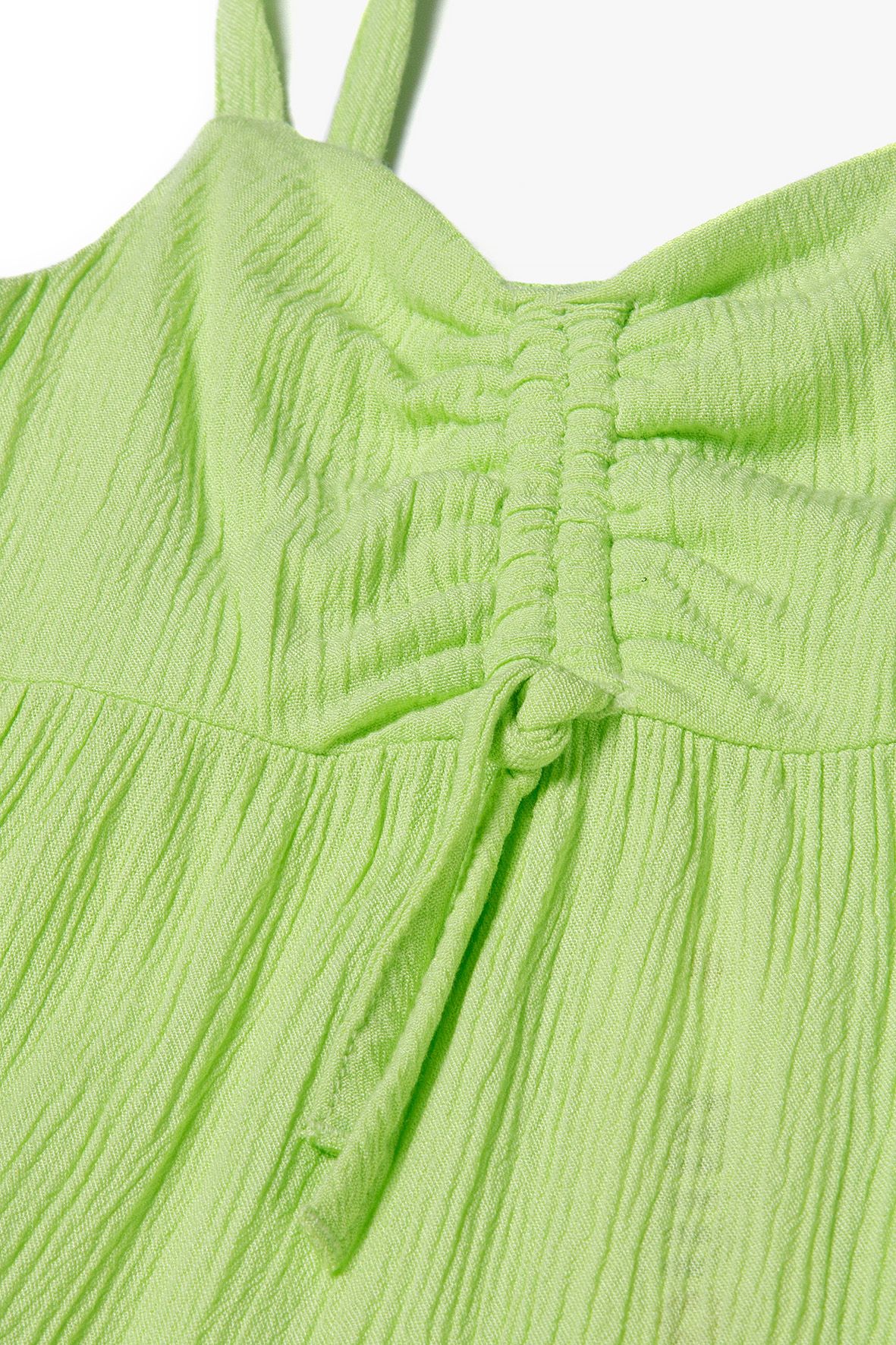 Close-up of lime-green sundress's ruched V-neck bodice and hanging center drawstring.