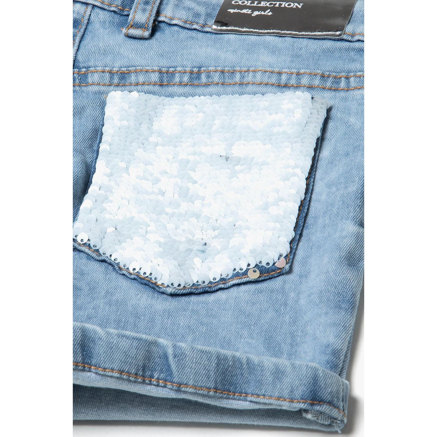 Close-up of back pocket with white sequin embellishment on light blue denim, showing turn-up hem detail and contrast stitching