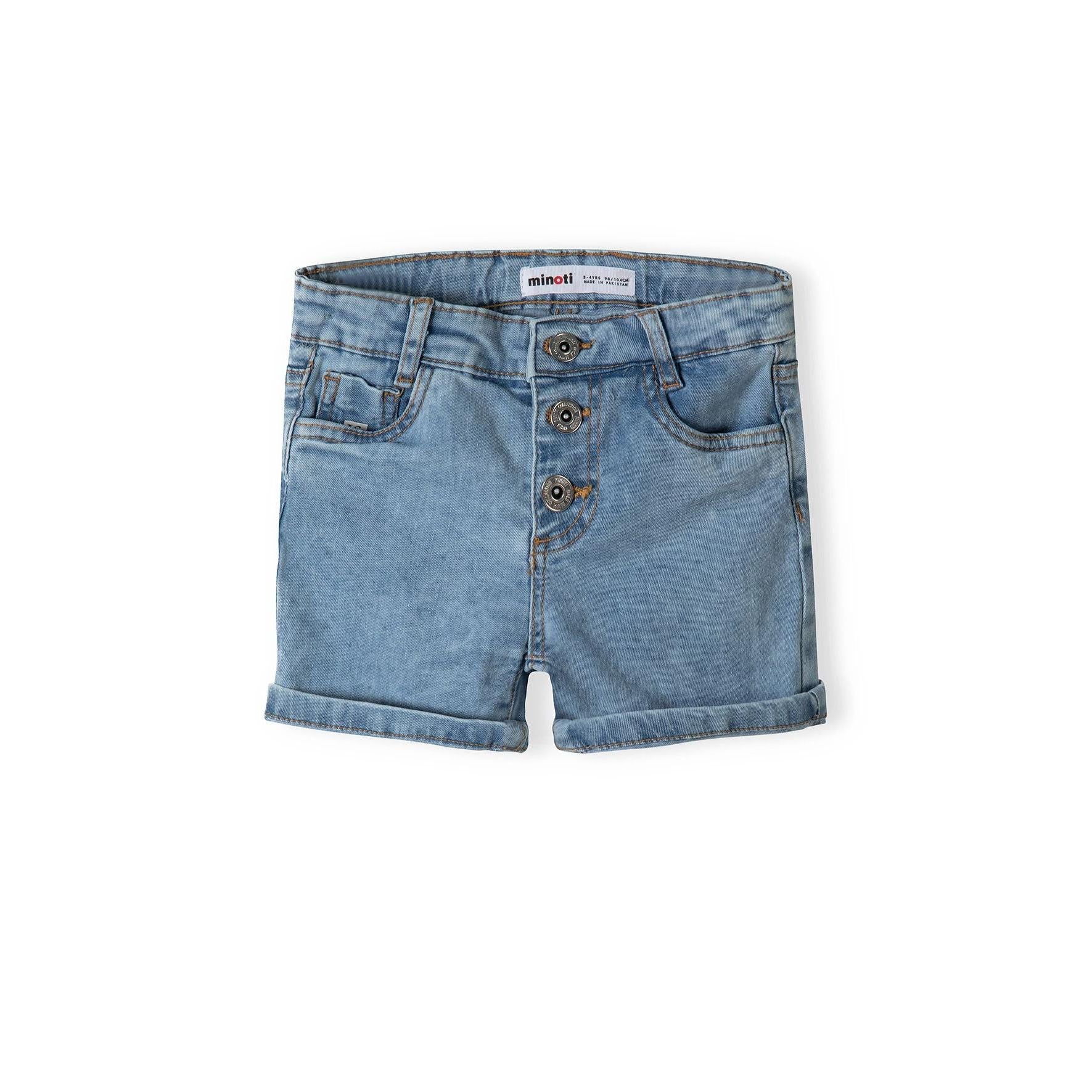 Close-up detail of light blue denim shorts showing three-button fly fastening, Minoti brand label, and front pocket construction