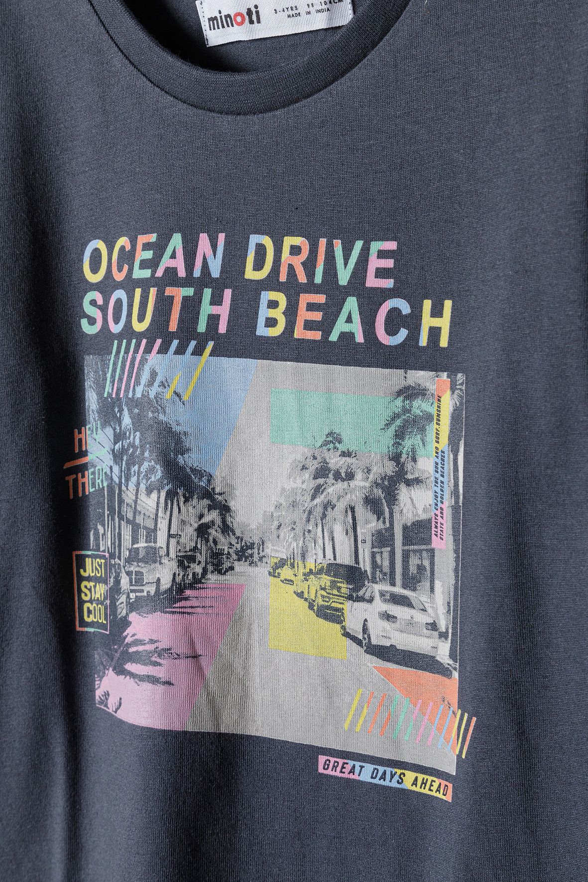 Close-up of Ocean Drive South Beach print with palms and cars.