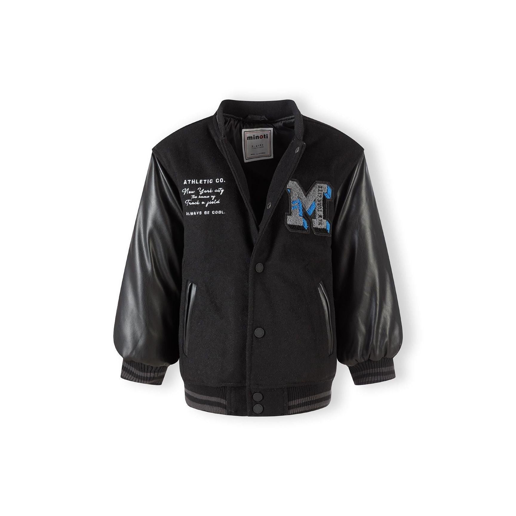 Black baseball jacket laid flat showing Minoti label, press stud fastening, and contrast between felt body and faux leather sleeves