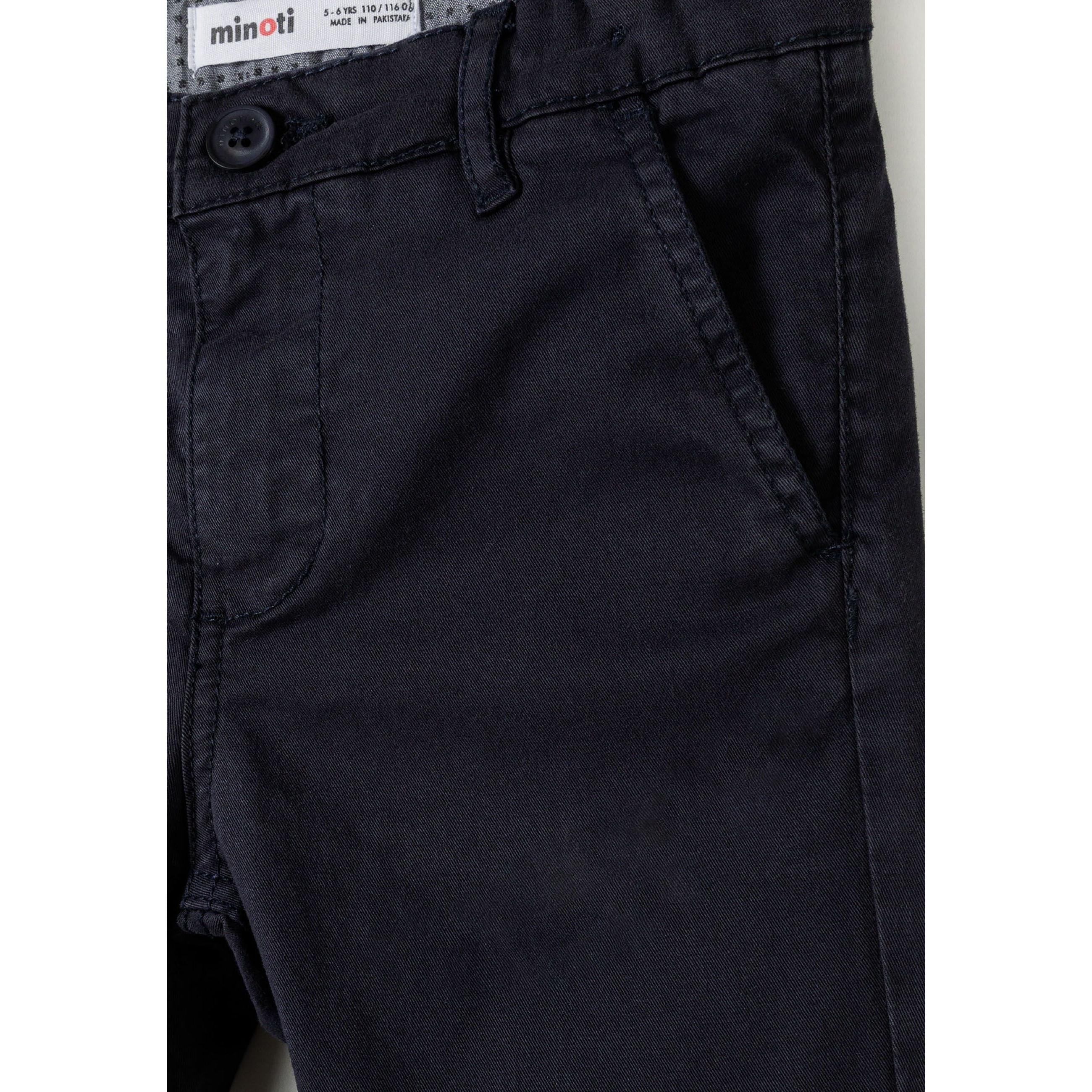 Close-up detail of navy chino trouser waistband showing Minoti label, button fastening and front pocket
