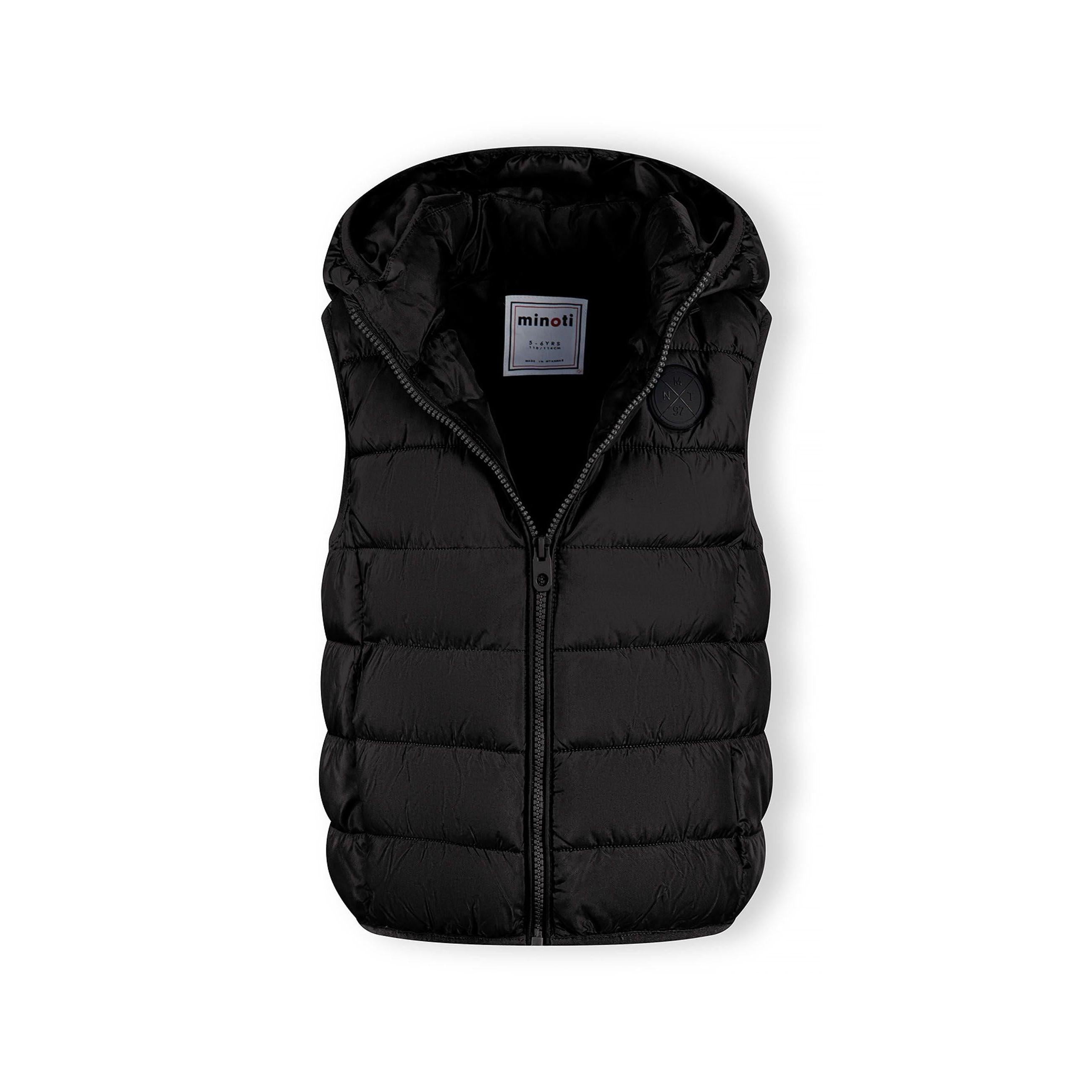 Detail view of black padded gilet front zipper and quilted chest panel construction