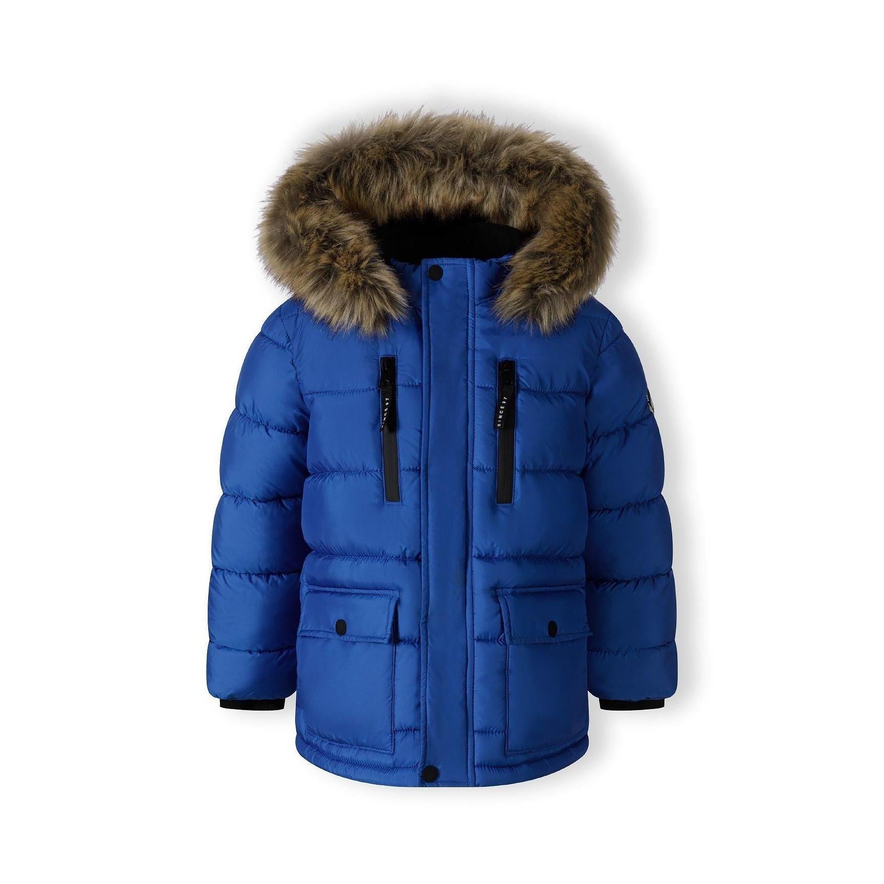 Cobalt blue puffer jacket laid flat showing detachable faux fur hood, quilted panels, and chest pockets on white surface