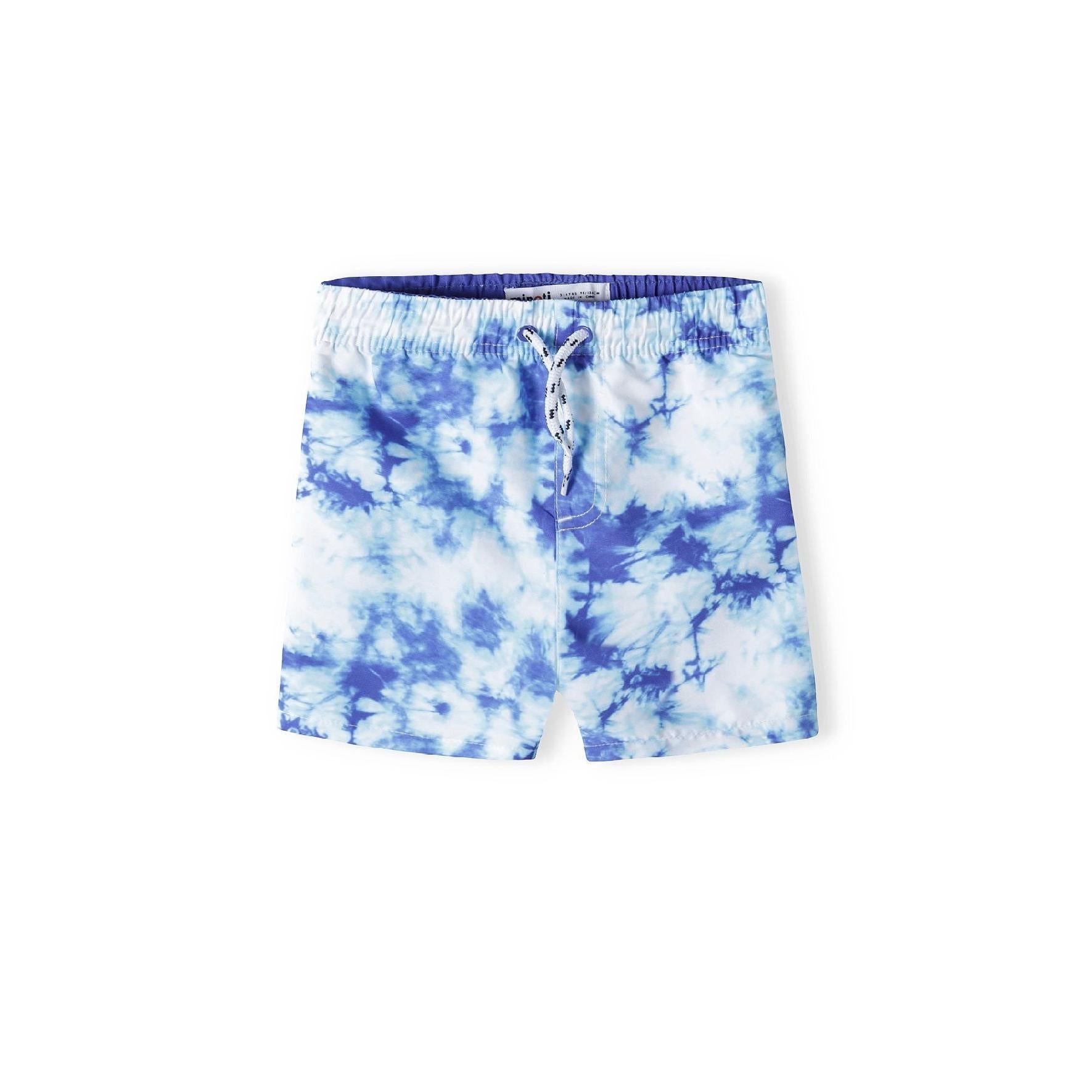 Blue tie-dye board shorts displayed flat against white background, showing vibrant cloud-like pattern and drawstring waistband
