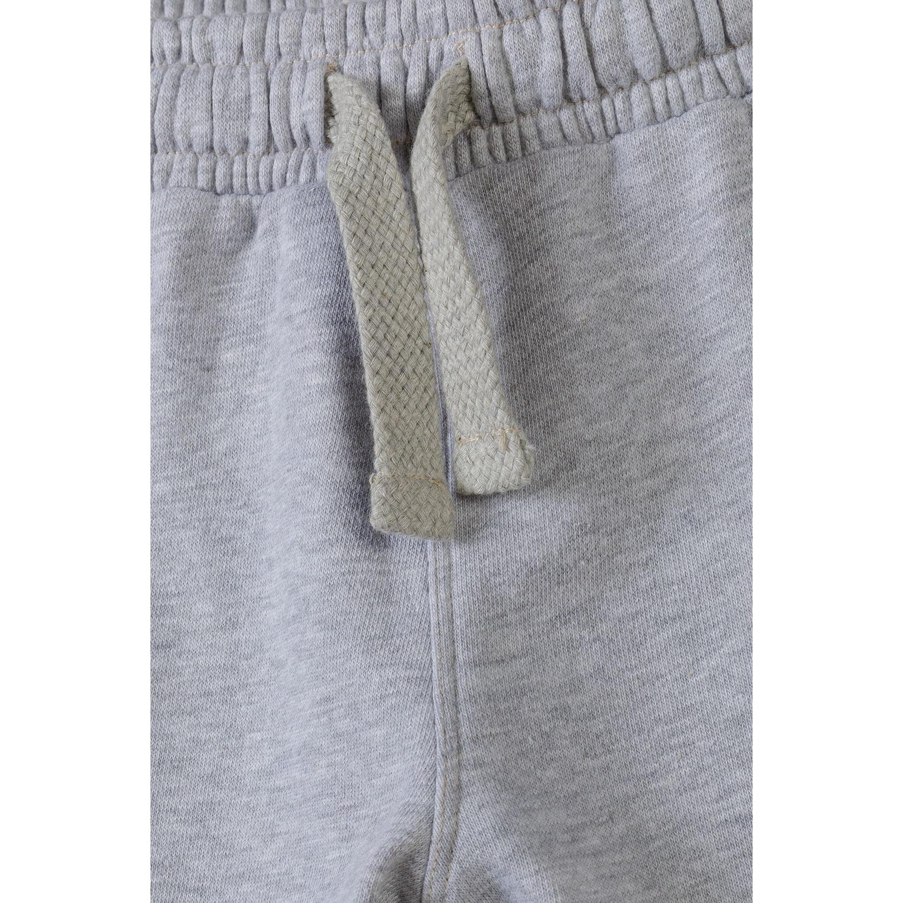 Close-up detail of grey fleece shorts showing cream drawstring ties and elasticated waistband texture