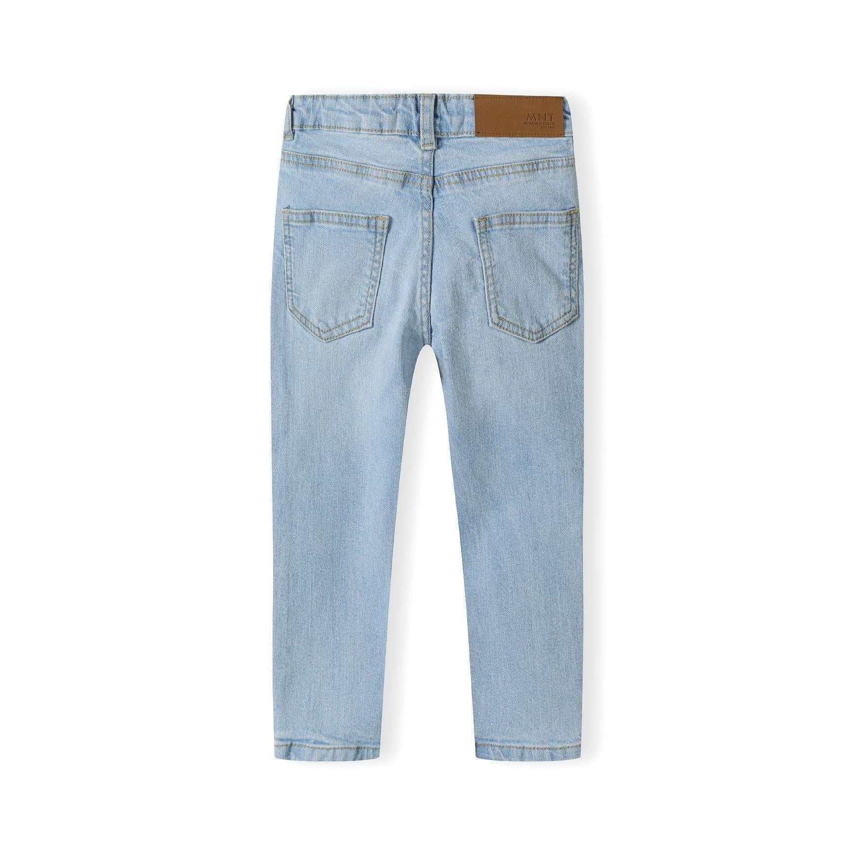 Back view of light blue denim jeans showing two rear pockets and brown leather waistband label on white background