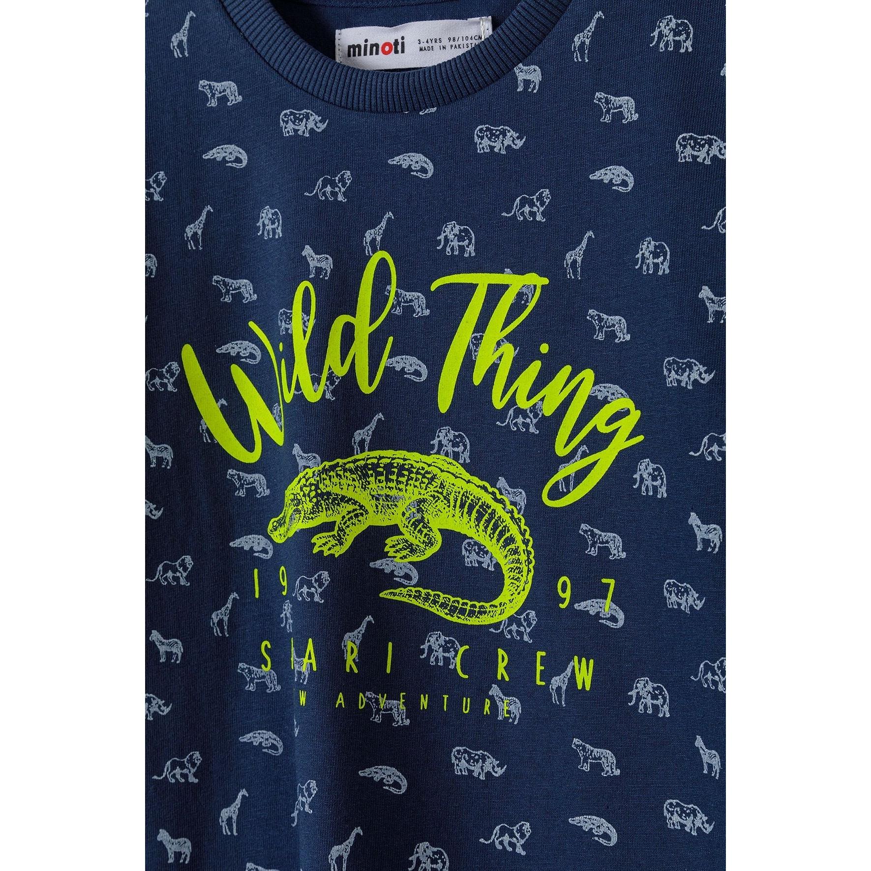 Close-up detail of navy t-shirt showing Wild Thing text in bright green with crocodile illustration and small white safari animals pattern