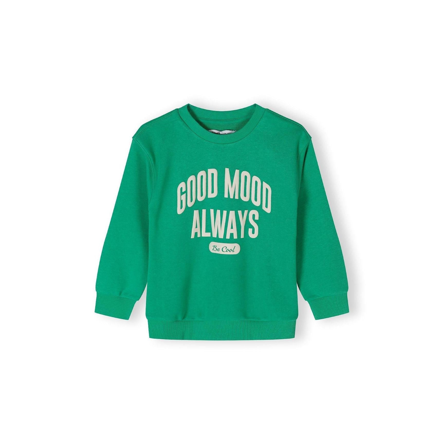 Back view of bright green oversized sweatshirt laid flat showing plain design with ribbed crew neck and cuffs