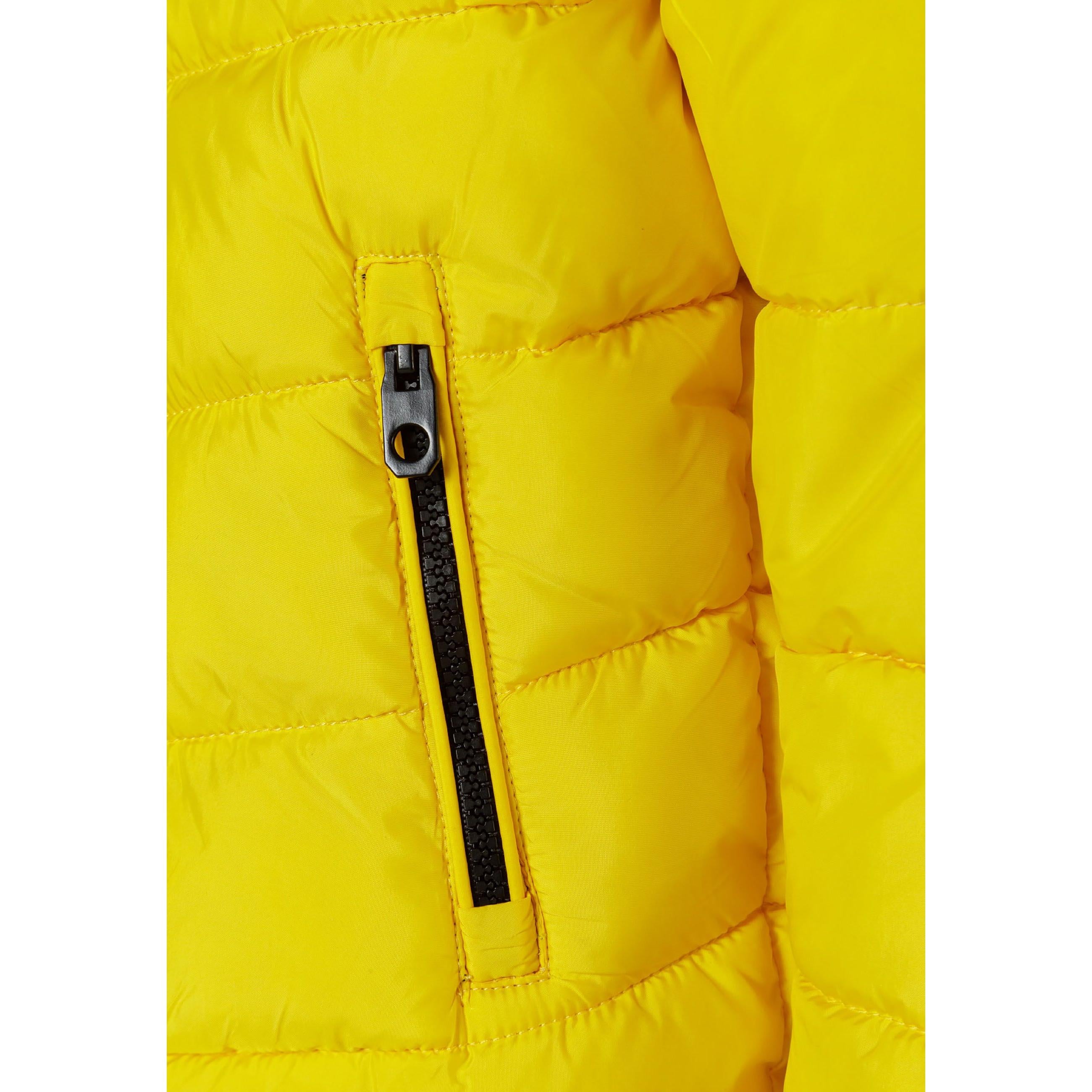 Close-up detail of black fabric label on yellow padded jacket showing Minoti brand text and sizing information