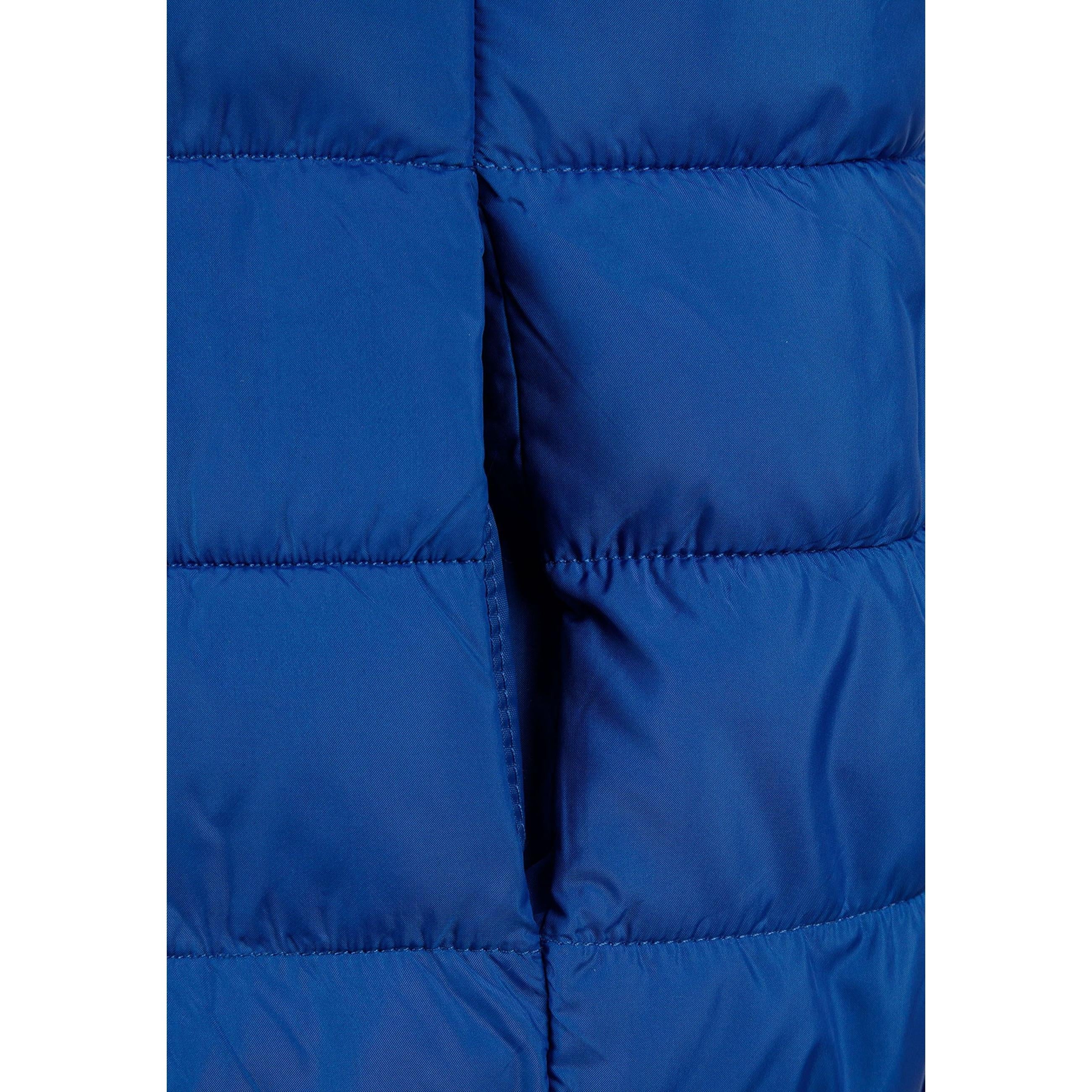 Close-up detail of cobalt blue padded gilet showing zip fastening, hood attachment and quilted texture
