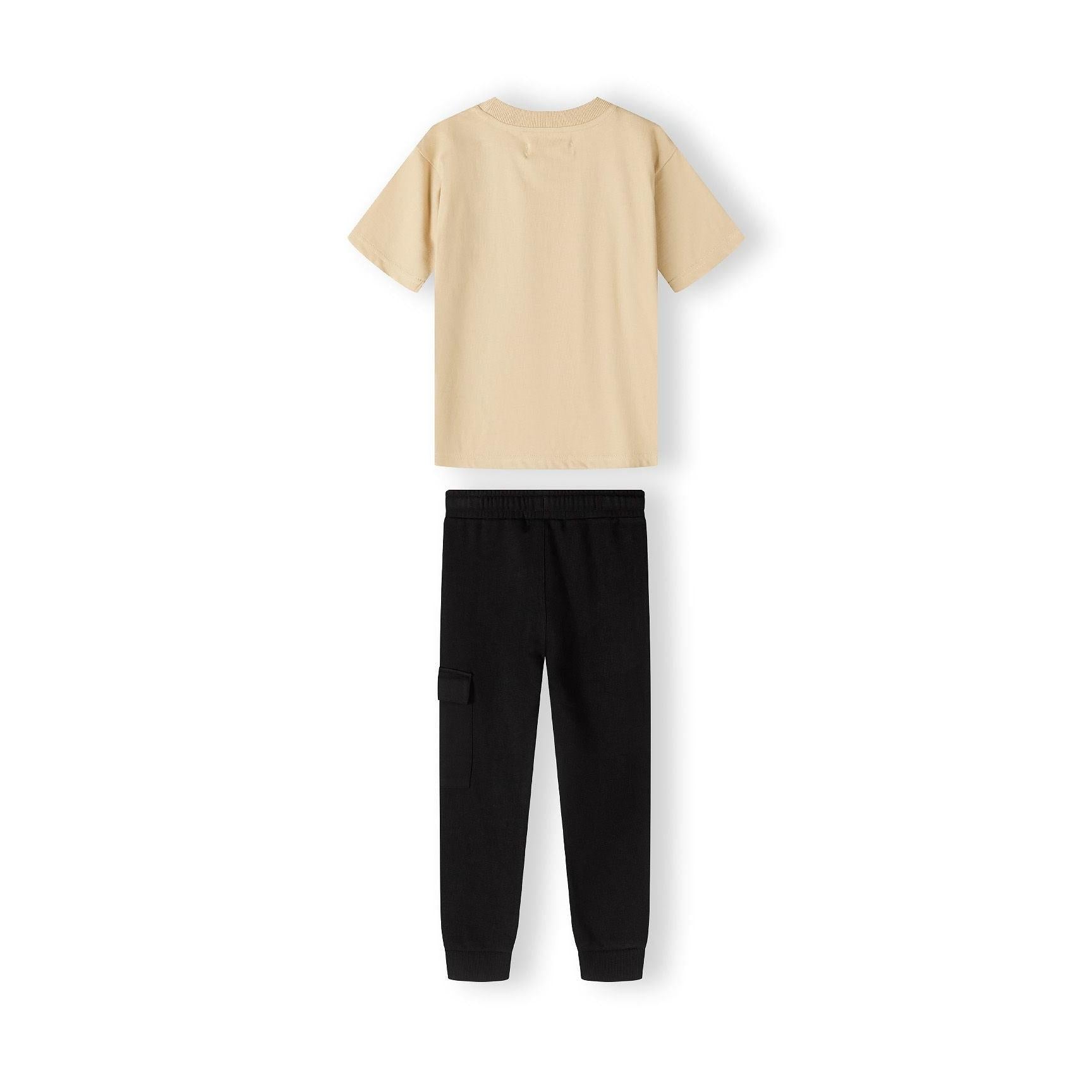 Close up detail of black fleece joggers showing drawstring waistband and green label patch