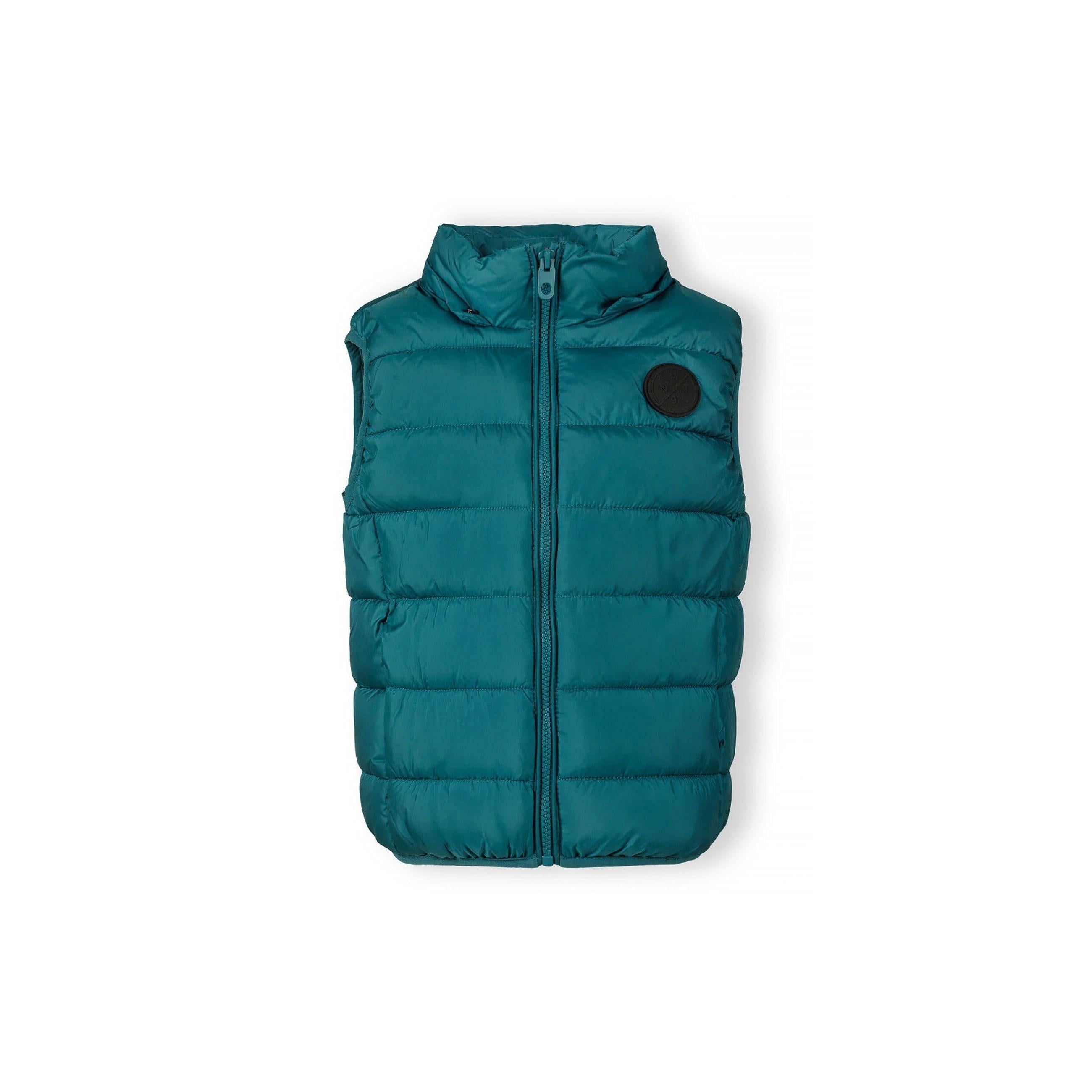 Close-up detail of green quilted fabric showing padded construction and stitching pattern in teal green shade