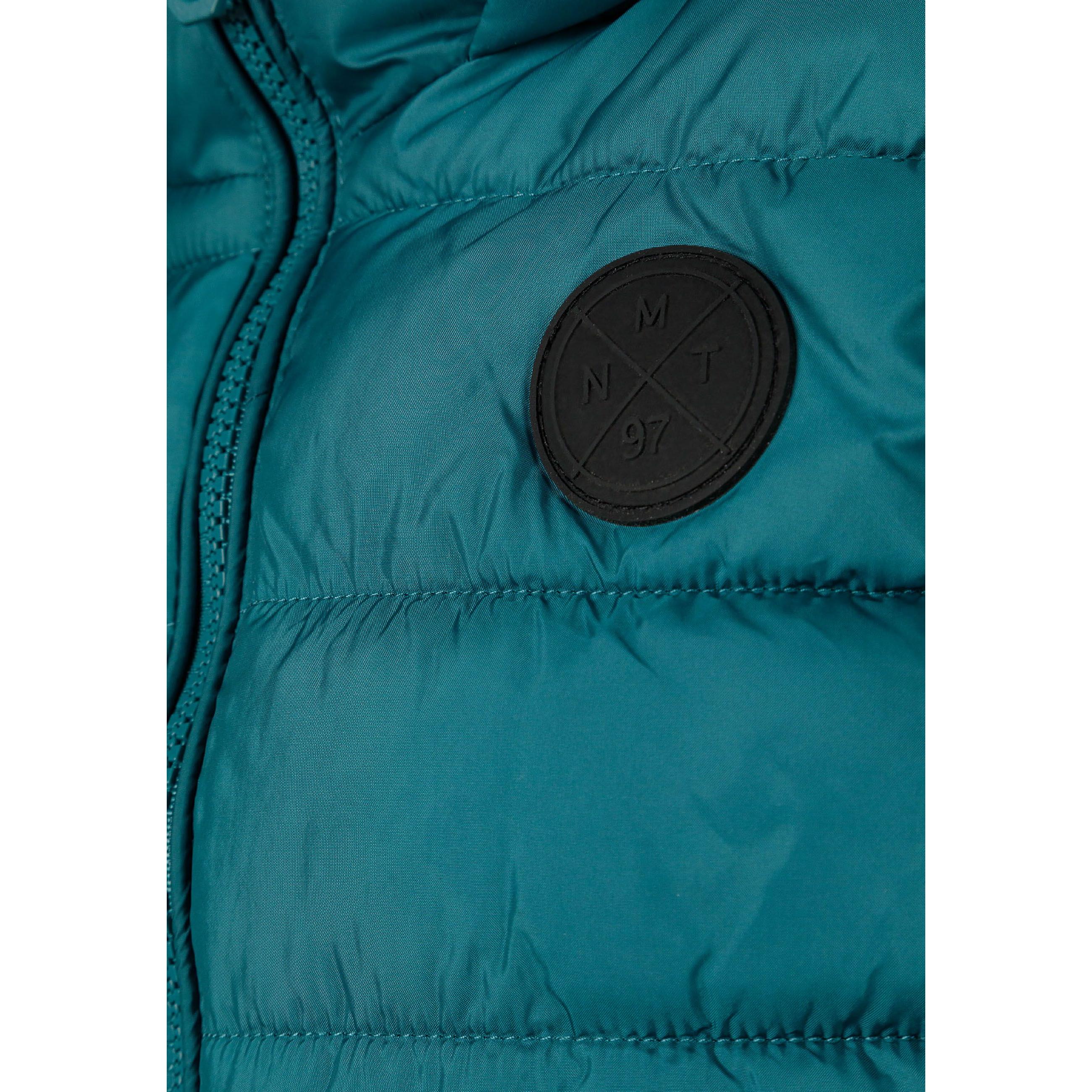 Close-up detail of green quilted fabric showing padded construction and stitching pattern in teal green shade