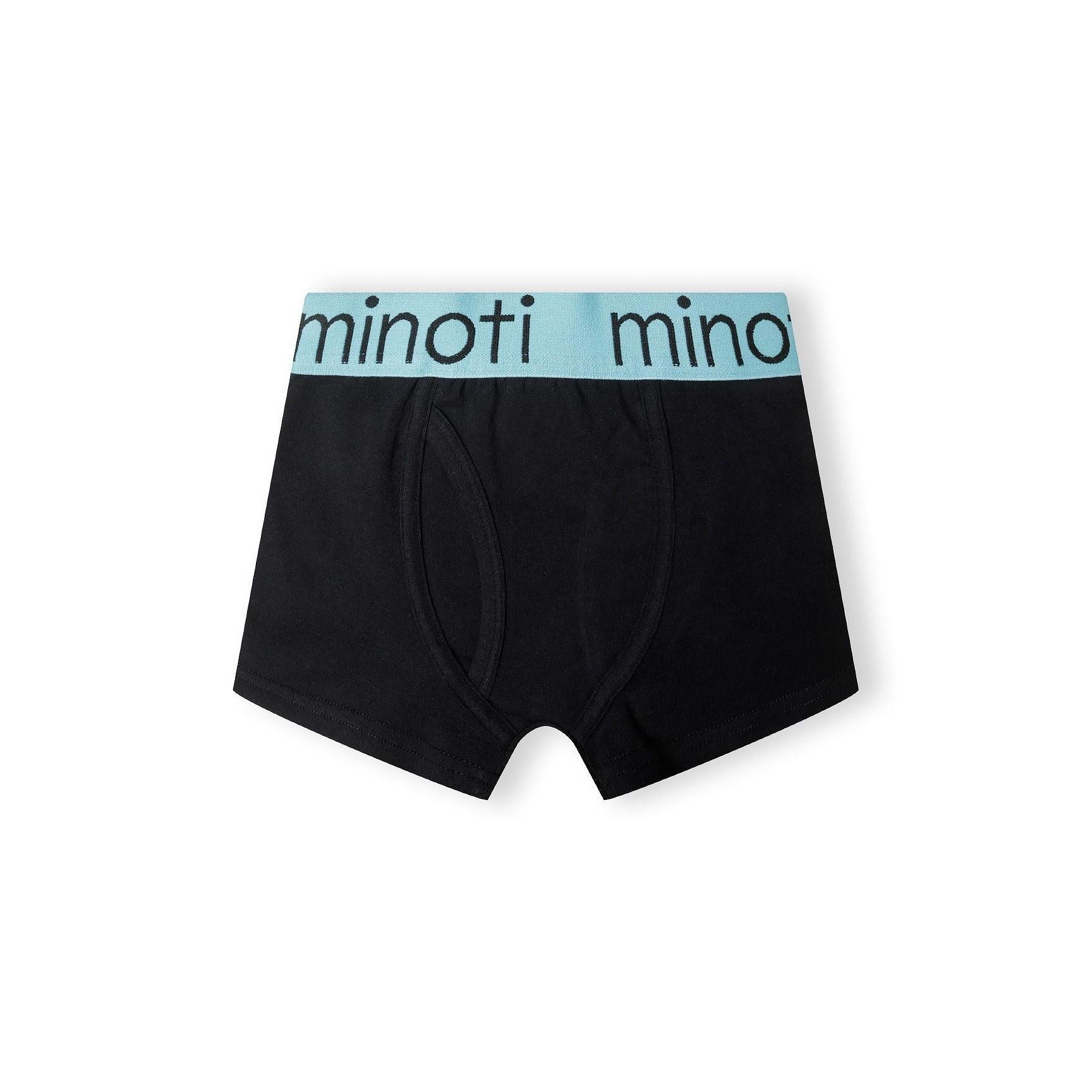 Single black trunk with orange waistband featuring Minoti branding, laid flat on white background displaying the comfortable fit and quality construction