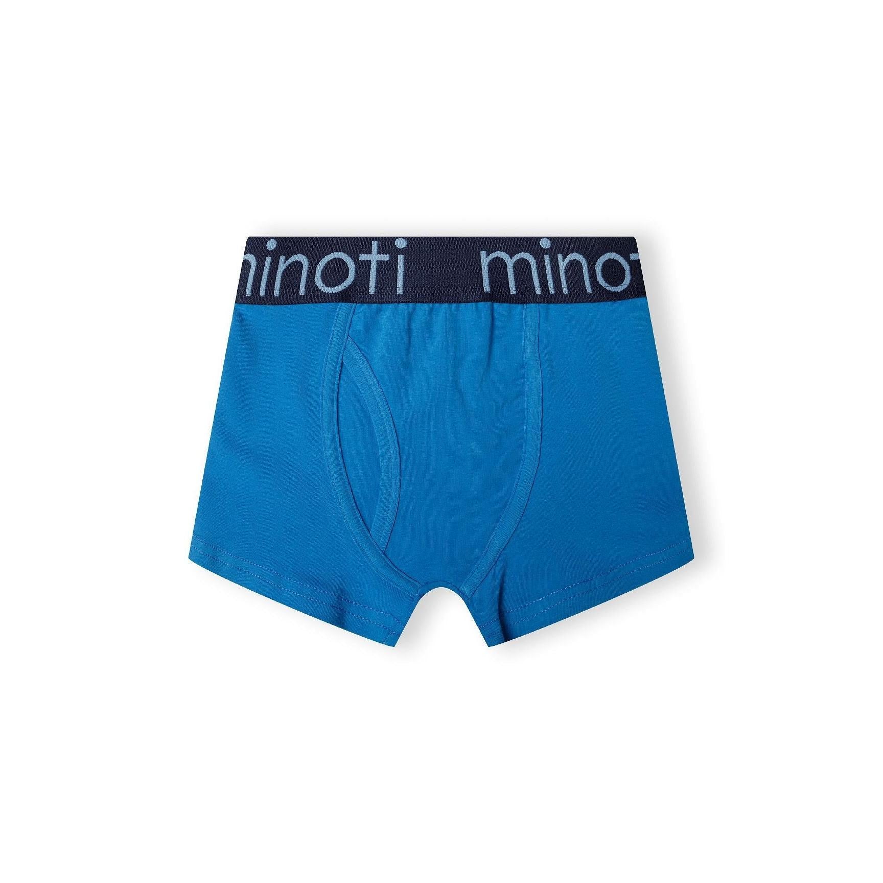 Light blue trunk with branded elastic waistband showing Minoti logo, front view on white background displaying comfortable trunk style
