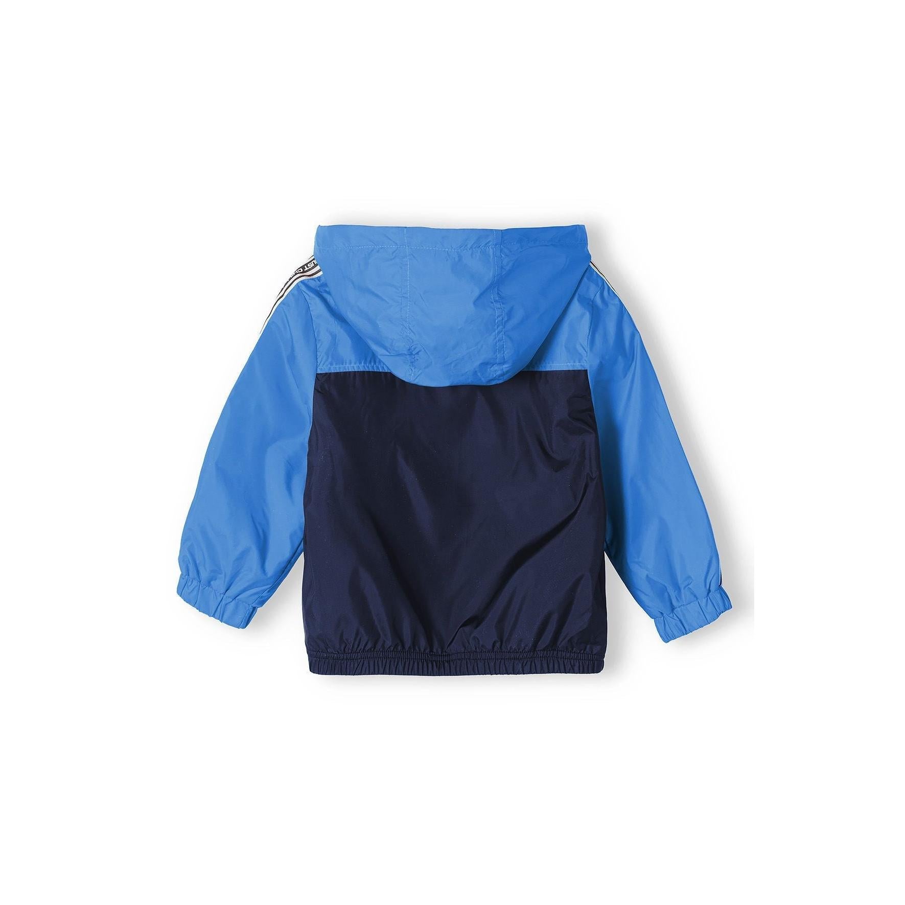 Back view of cobalt blue and navy windbreaker jacket showing colorblock design and hood detail against white background