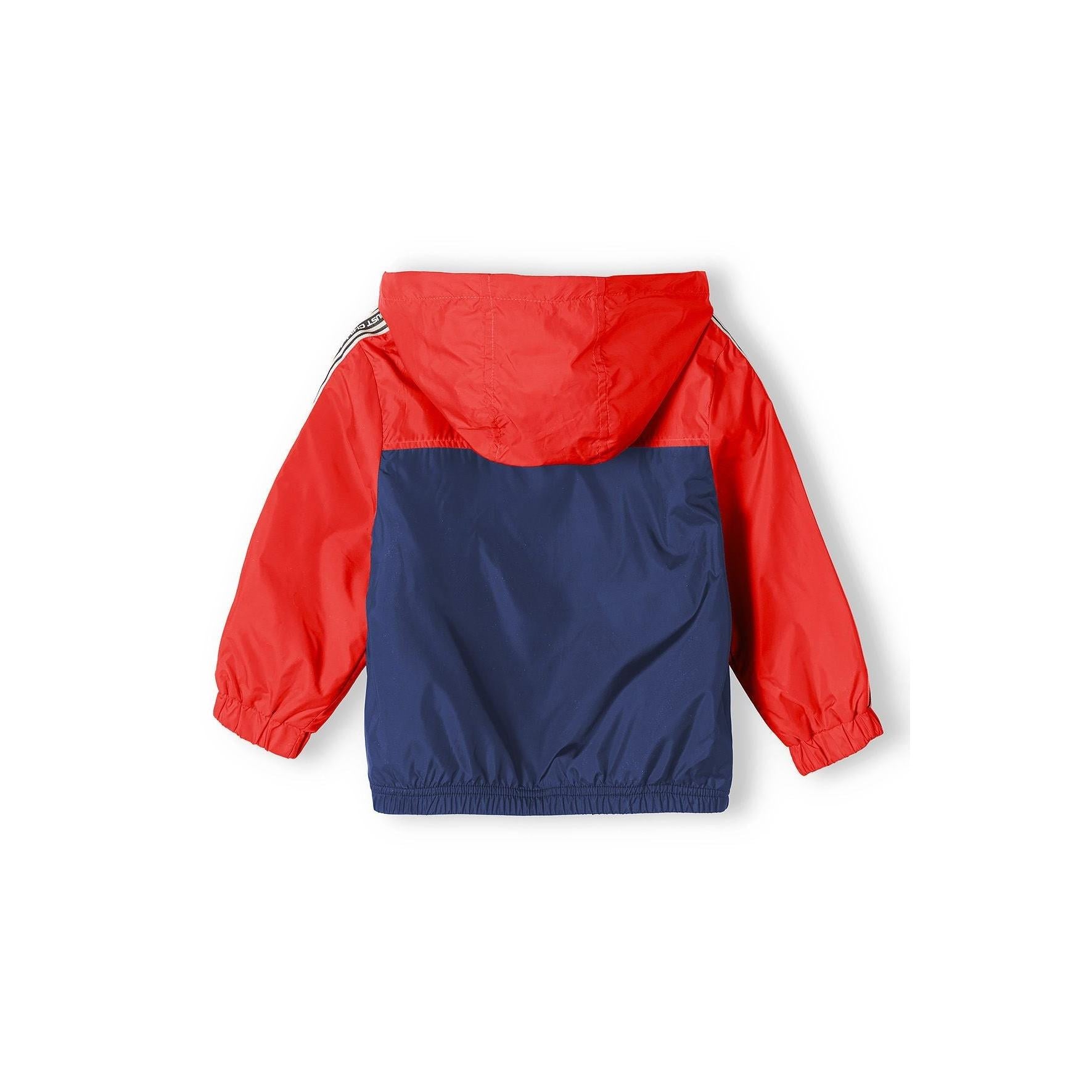 Close-up interior view of windbreaker showing red mesh lining, Minoti label, and construction details