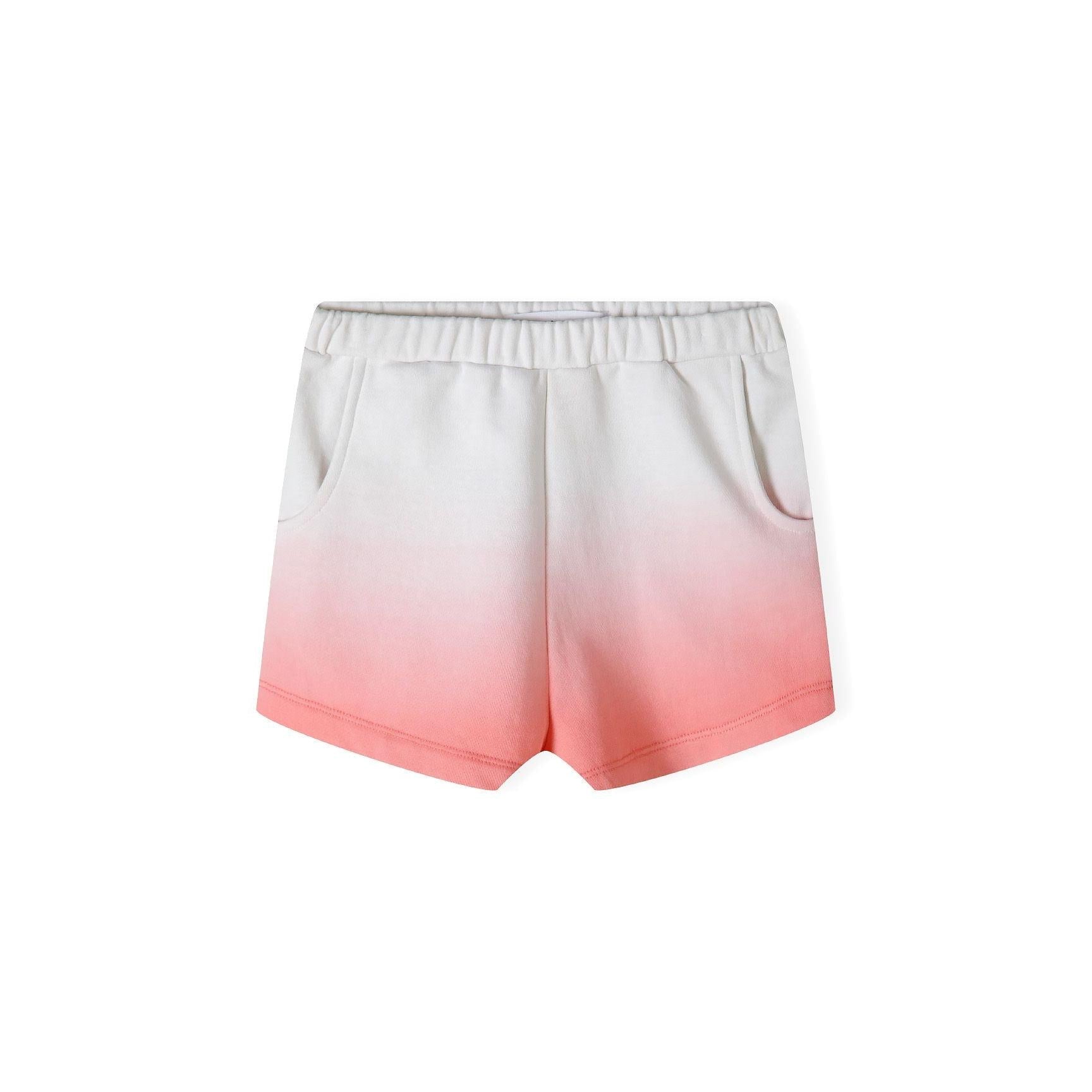 Close-up detail of sparkly gold SUNSHINE lettering on coral gradient fleece sweatshirt showing texture and Minoti label