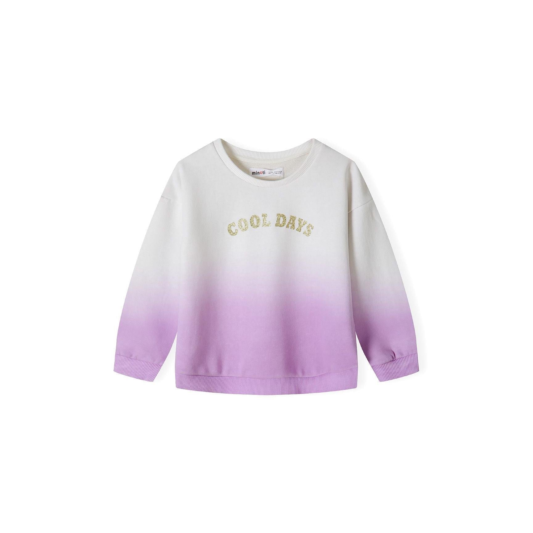 Close-up detail of cream to purple ombré fleece fabric with golden glitter 'Cool Days' text and Minoti brand label