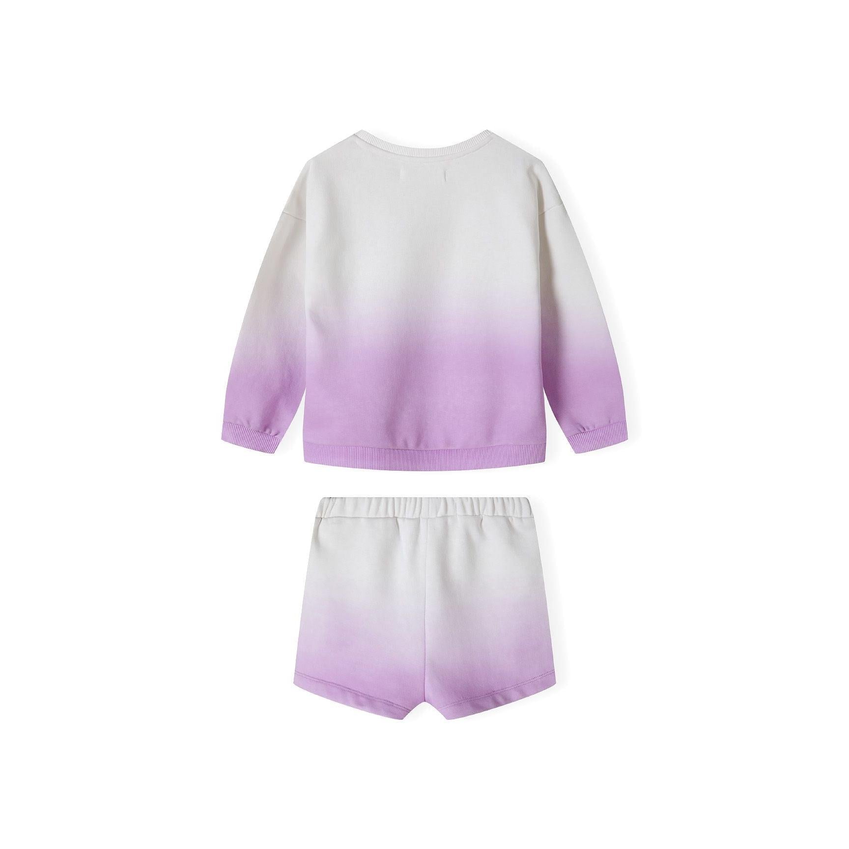 Close-up detail of cream to purple ombré fleece fabric with golden glitter 'Cool Days' text and Minoti brand label