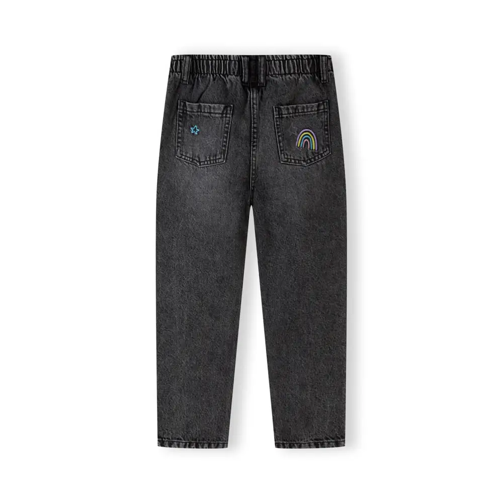 Black embroidered jeans laid flat showing back view with rainbow embroidery on right pocket and star detail on left pocket against white background