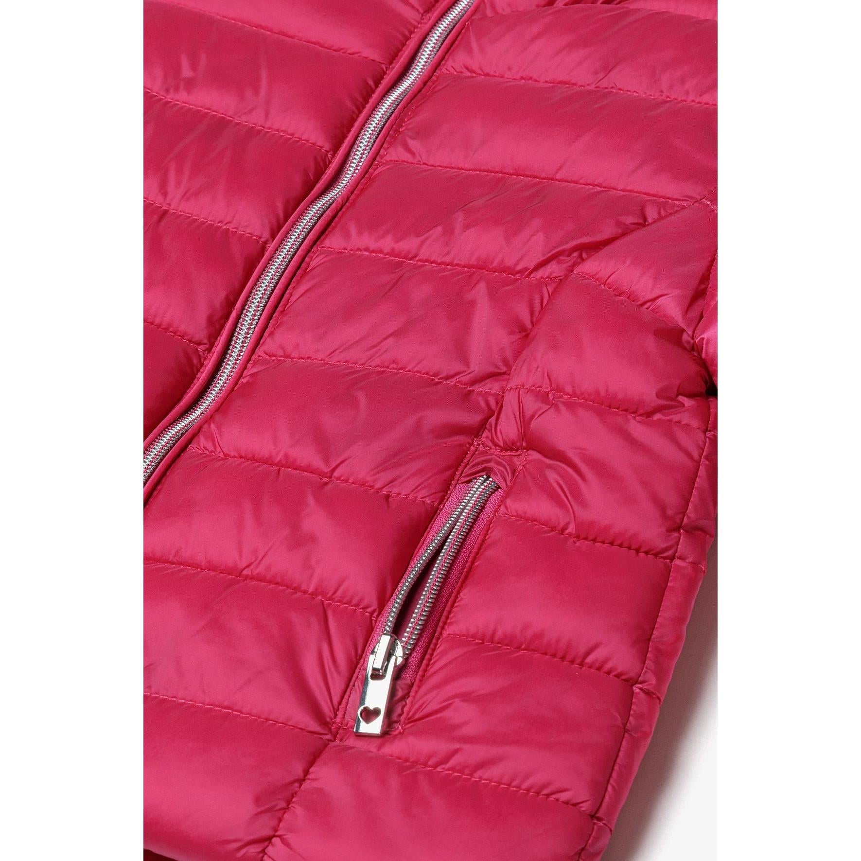 Close-up detail of pink padded jacket showing open front zip with navy blue lining and quilted exterior construction