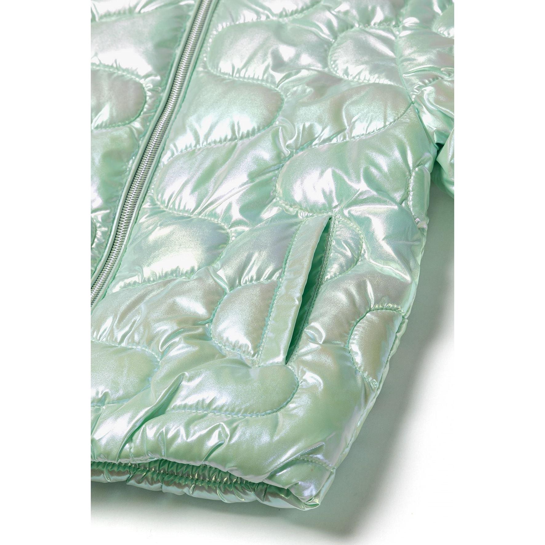 Close-up detail of mint green quilted jacket showing zip closure, quilted texture and sleeve construction
