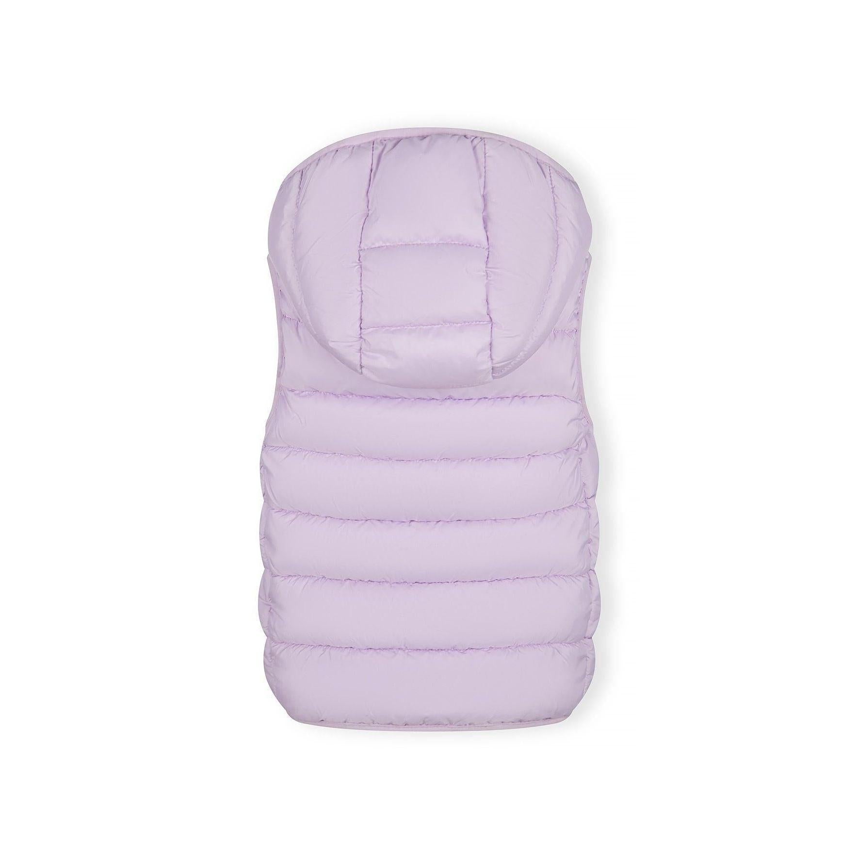 Close-up detail of lilac quilted fabric texture showing stitching pattern and Minoti brand label with glitter finish