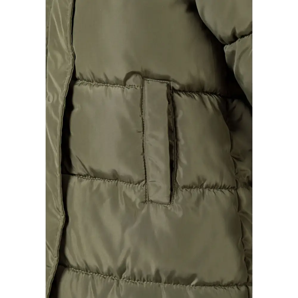 Close-up detail of khaki quilted coat showing interior pocket with zipper closure and quilted texture of the fabric