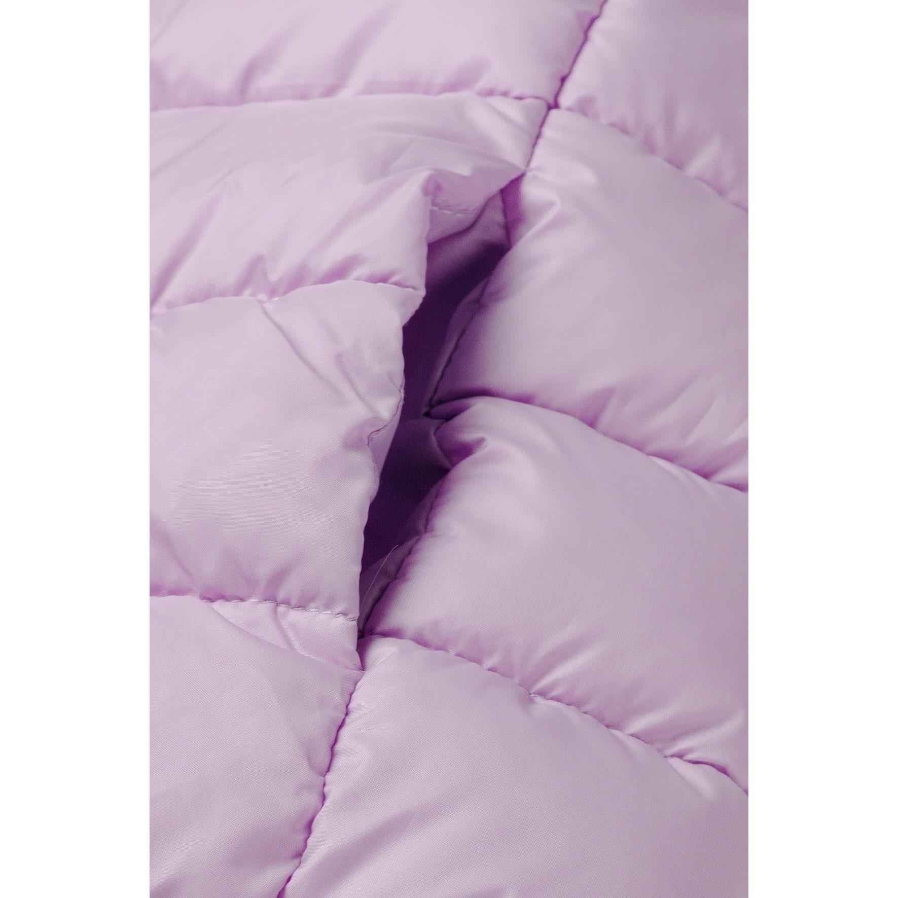 Detail view of lilac quilted jacket zip area and quilted padding pattern with hood visible