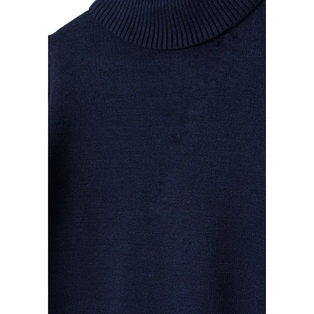 Close-up detail of navy fine knit turtleneck showing ribbed collar construction and smooth knit fabric texture against black background